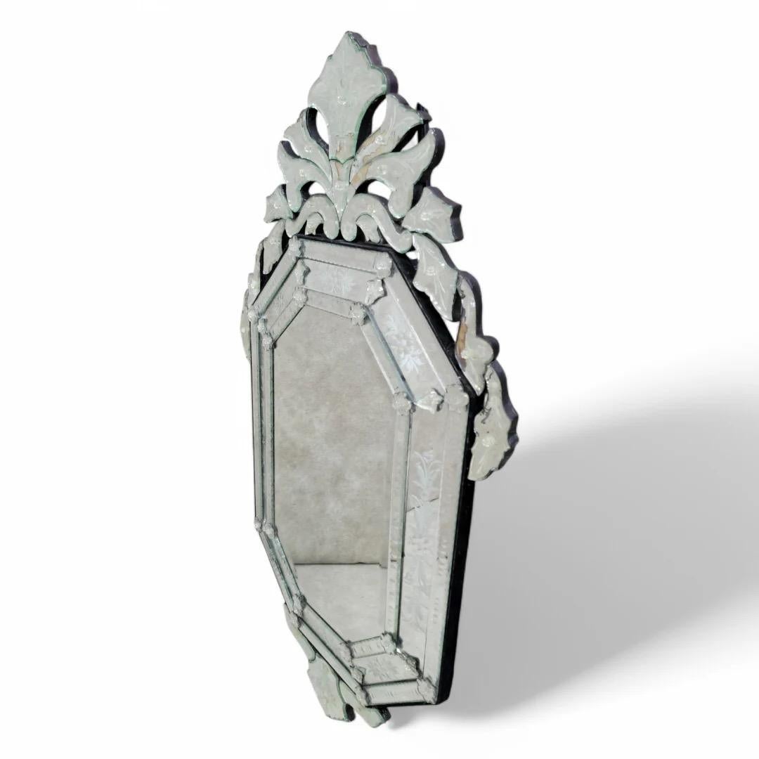 Vintage Venetian Etched Glass Wall Mirror

A Venetian wall mirror with an elaborately detailed frame, decorated with frosted and convex floral designs.

Circa Mid 20th Century 

Dimensions:
H: 53