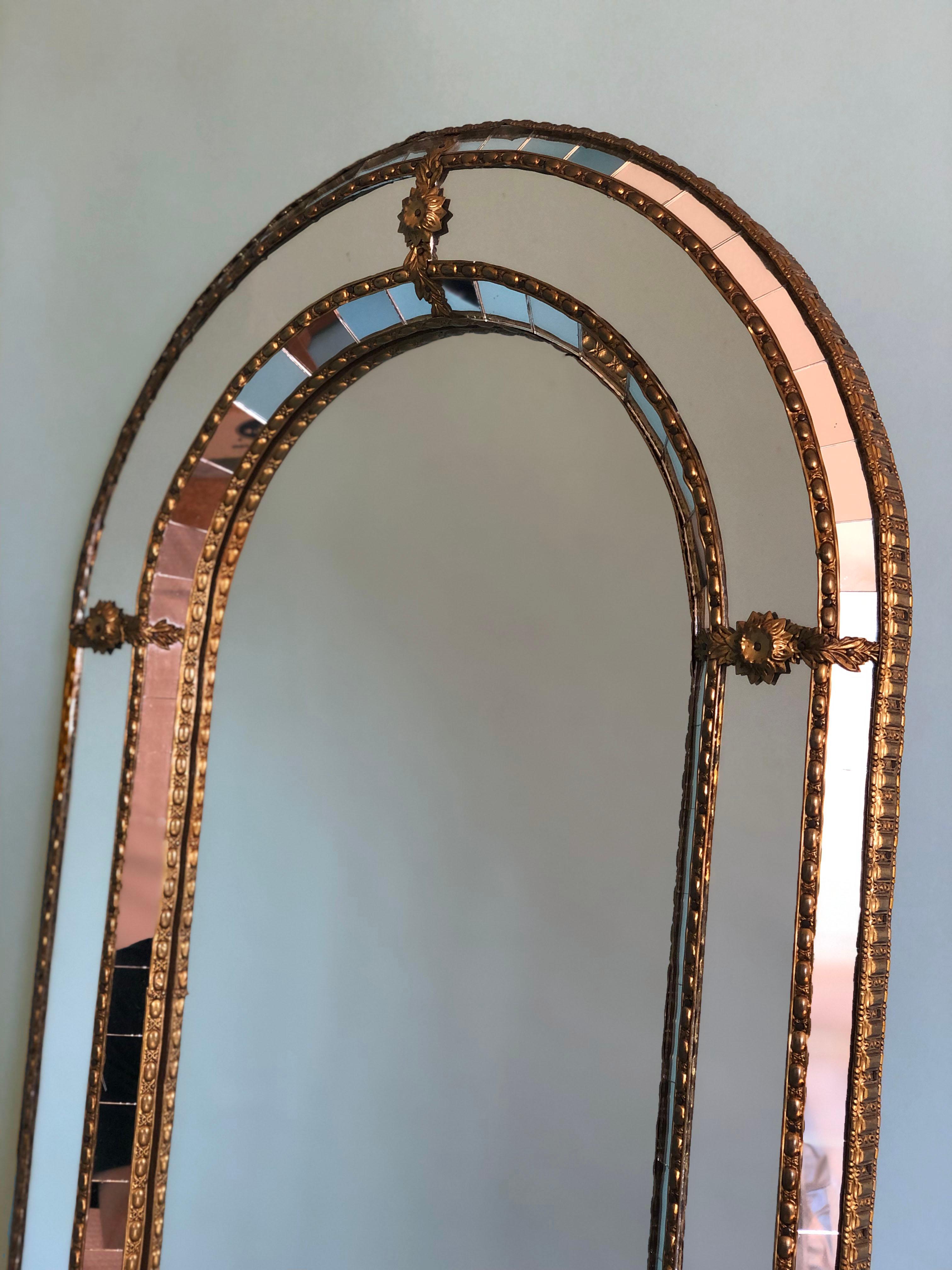 Beautiful Spanish full length mirror with a Venetian glass frame with a brass golden strip. The frame is made with small crystals both on the outside and inside, and larger ones in the center line. The brass strip holds the mirrors