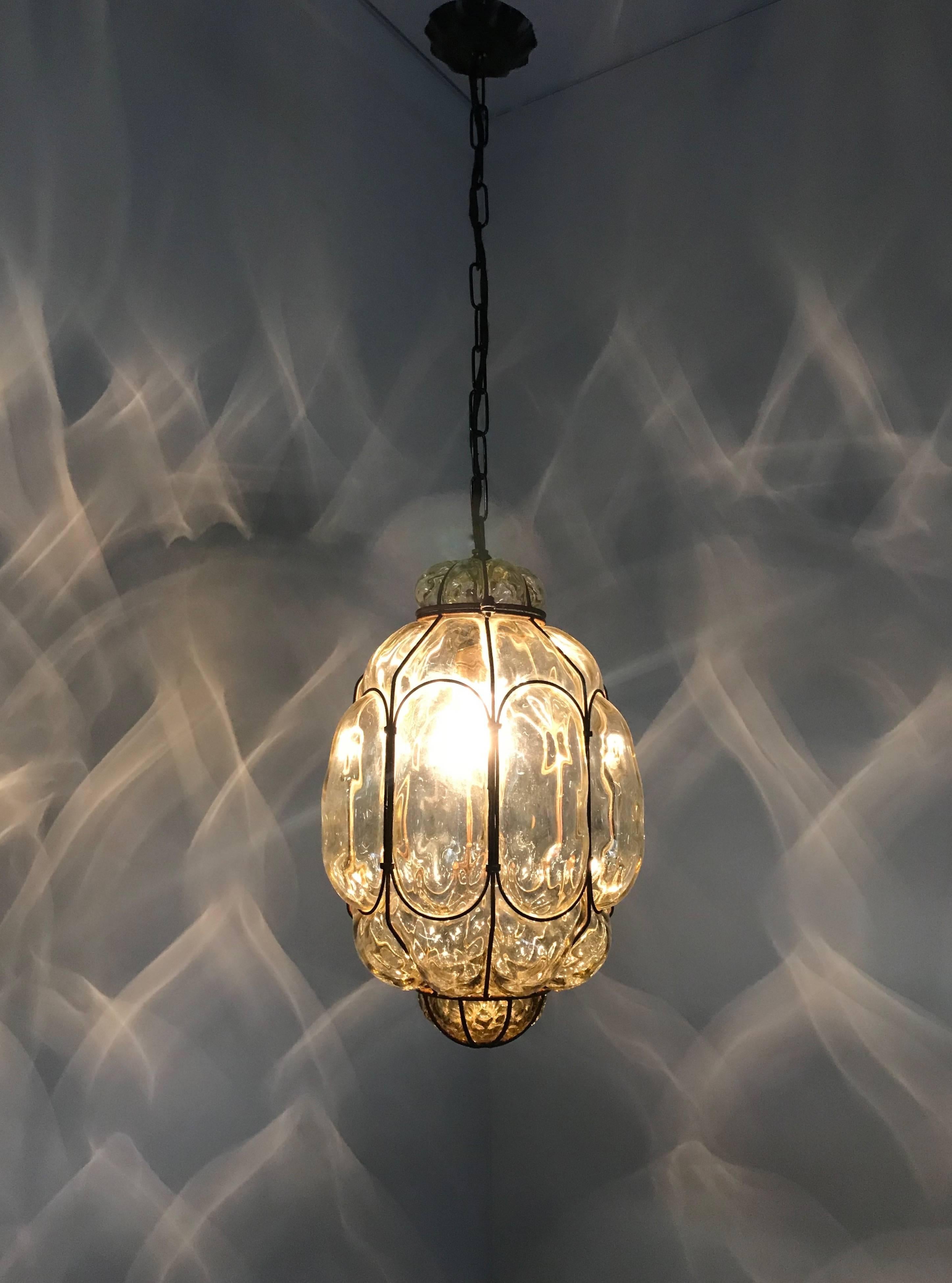 Early 20th century, Italian craftsmanship pendant. 

This stylish single light pendant is beautiful in shape and the mouth blown, green tinted glass is in excellent condition. It comes with a chain and metal canopy and the bulb can easily be