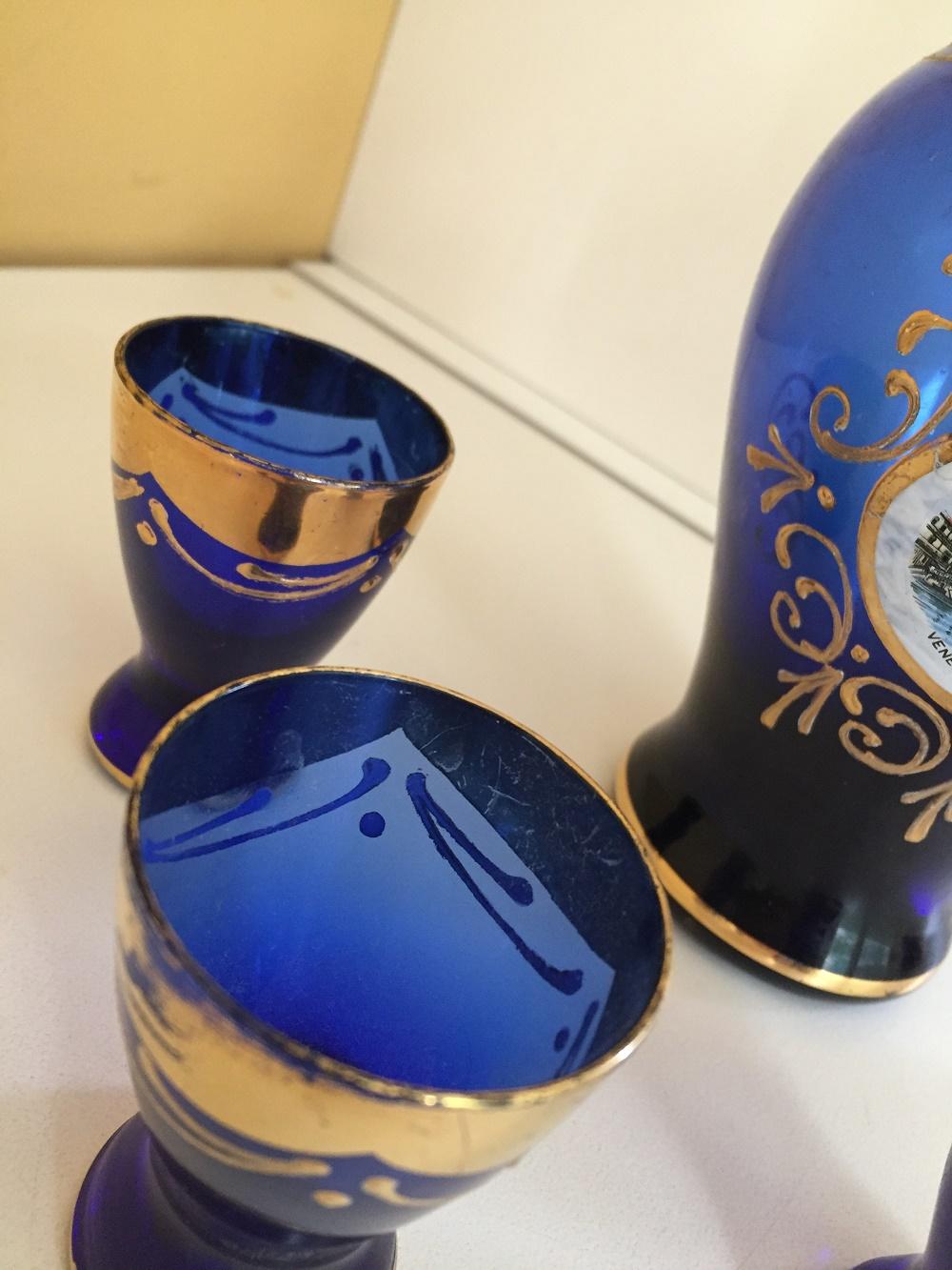 Vintage Venetian Murano glass gold leaf carafe and four glasses
Rich cobalt blue with hand painted details in gold leaf, circa 1960. This Venetian glass carafe and matching cordial glasses are one of a kind. Perfect for your bar cart, étagère, atop