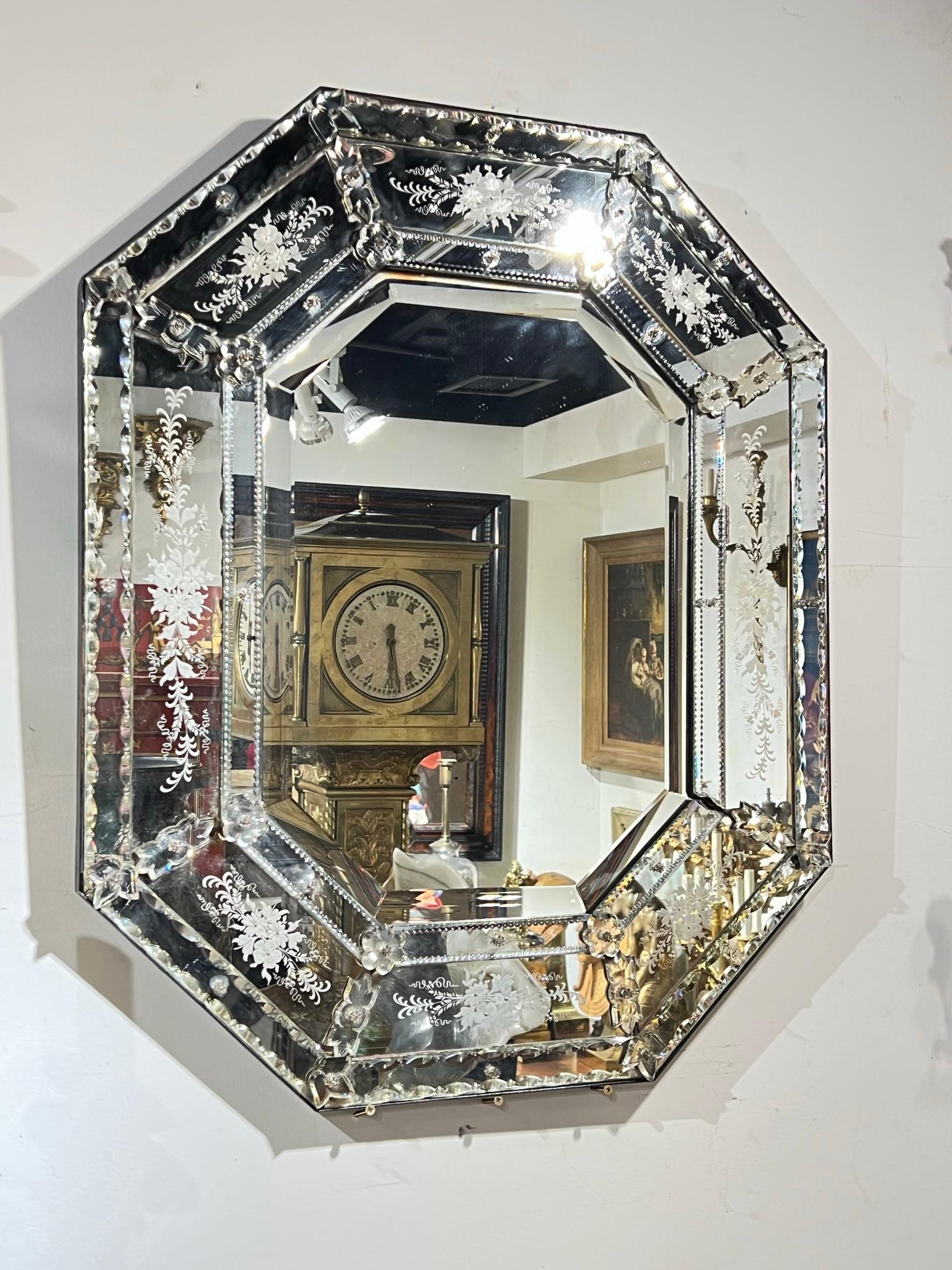 Semi Antique Italian wall mirror with exceptional engraved floral designs.  In very good condition.  One glass rosette missing.