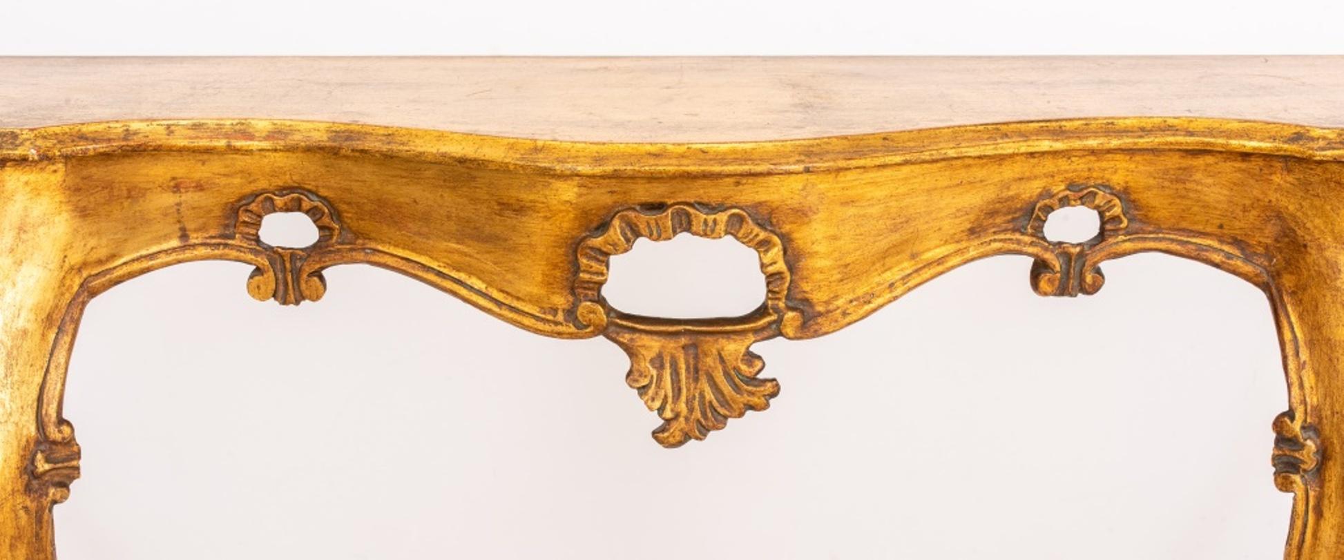 Vintage Venetian Rococo style giltwood console, circa 1960s or later, of elongated shaped form with reticulated scrolling apron on four cabriole legs. In good vintage condition. Wear consistent with age and use.

Dimensions: 33.5