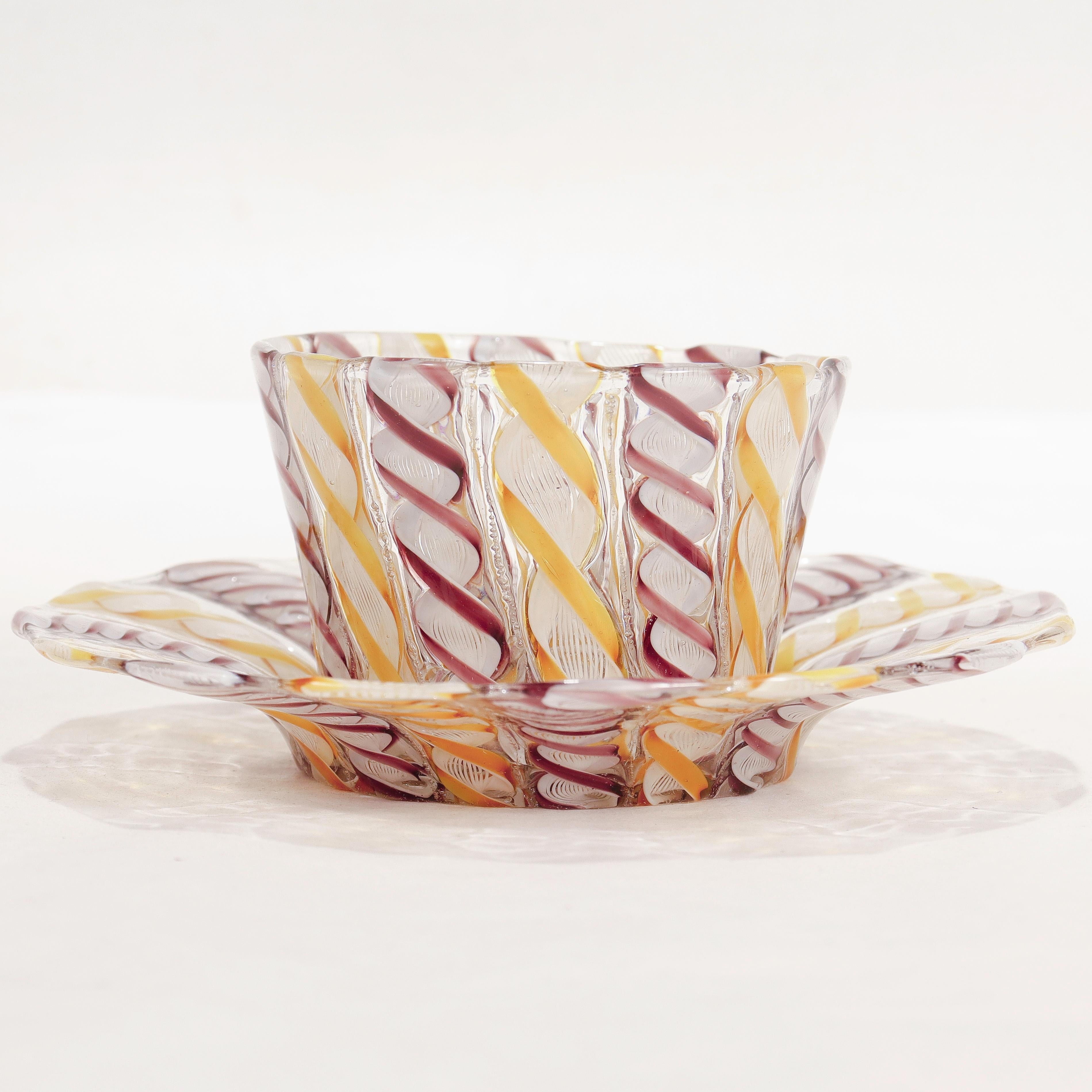 A fine vintage Italian glass finger bowl or handleless cup & saucer.

Attributed to Salviati.

Comprised of Zanfirico canes with purple, yellow, and white threads.

Simply a wonderful Venetian glass example!

Date:
Early 20th