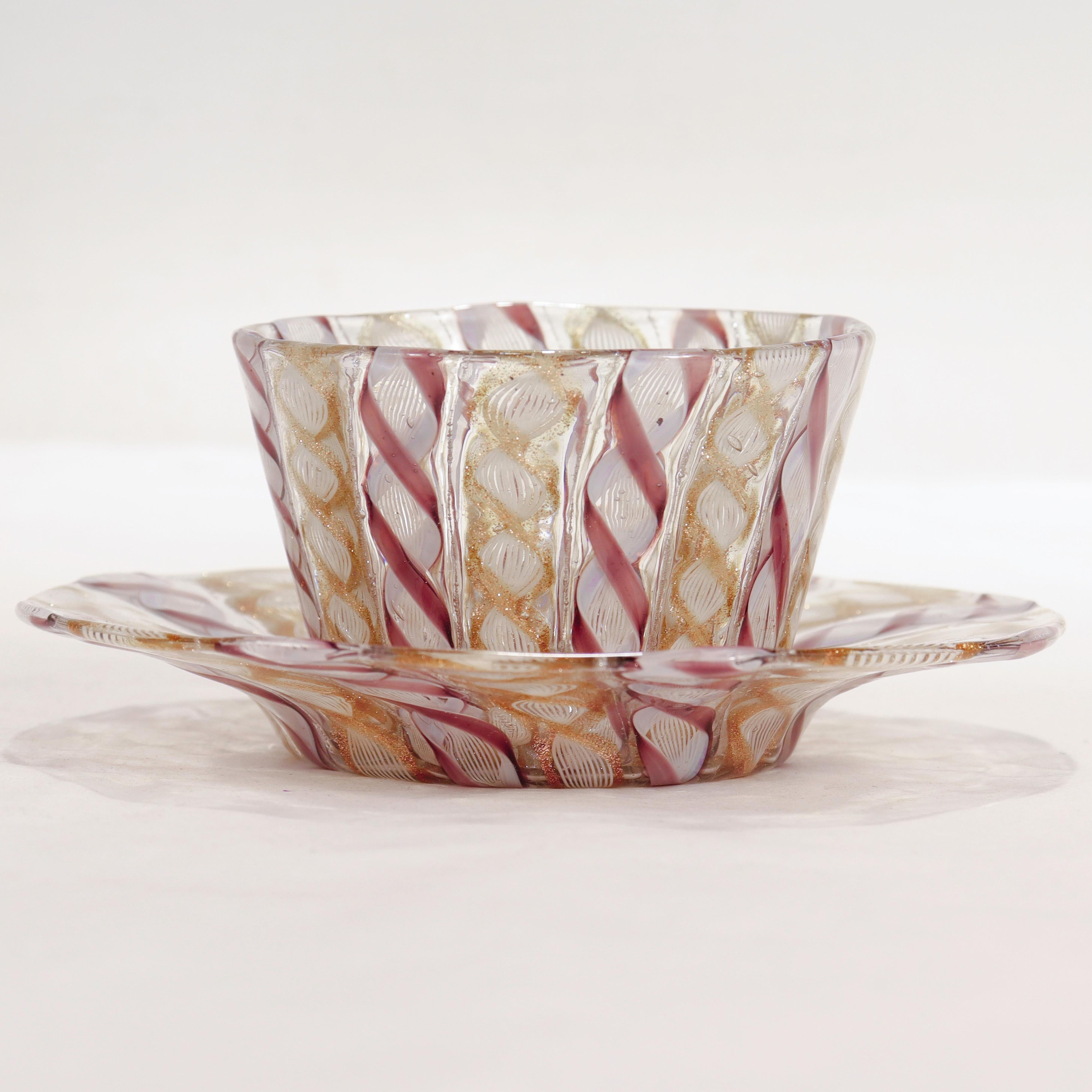 A fine vintage Italian glass finger bowl or handleless cup & saucer.

Attributed to Salviati.

Comprised of Zanfirico canes with purple, aventurine, and white threads.

Simply a wonderful Venetian glass example!

Date:
Early 20th Century

Overall