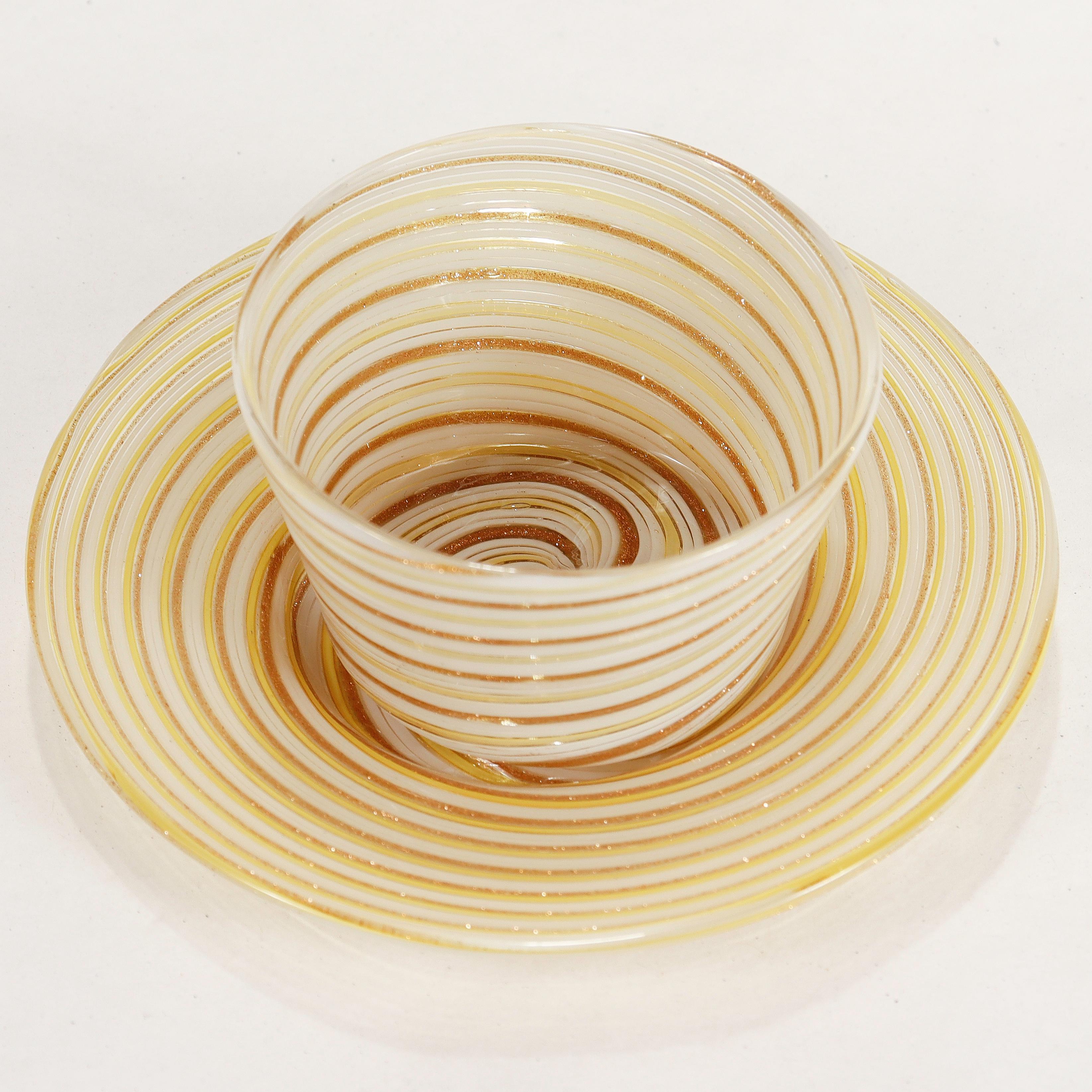 A fine vintage Italian glass finger bowl or handleless cup & saucer.

Attributed to Salviati.

Comprised of Mezza filigrana canes with white, yellow, and aventurine threads.

Simply a wonderful Venetian glass example!

Date:
Early 20th