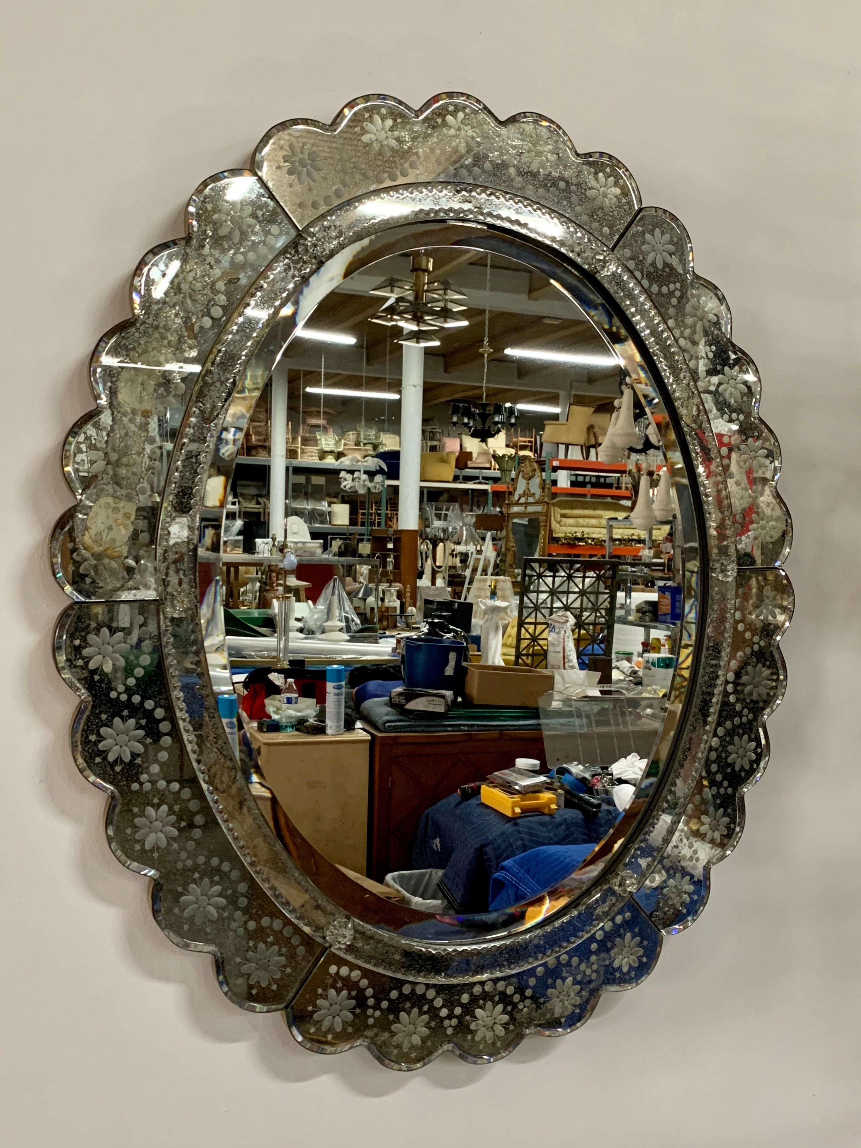 This antiqued venetian wall mirror has so much character and design elements. Scalloped framed and layers of mirrored accents with glass fleurettes. Despite its aged and distressed mirror finish, it is still beautiful and ready to hang!