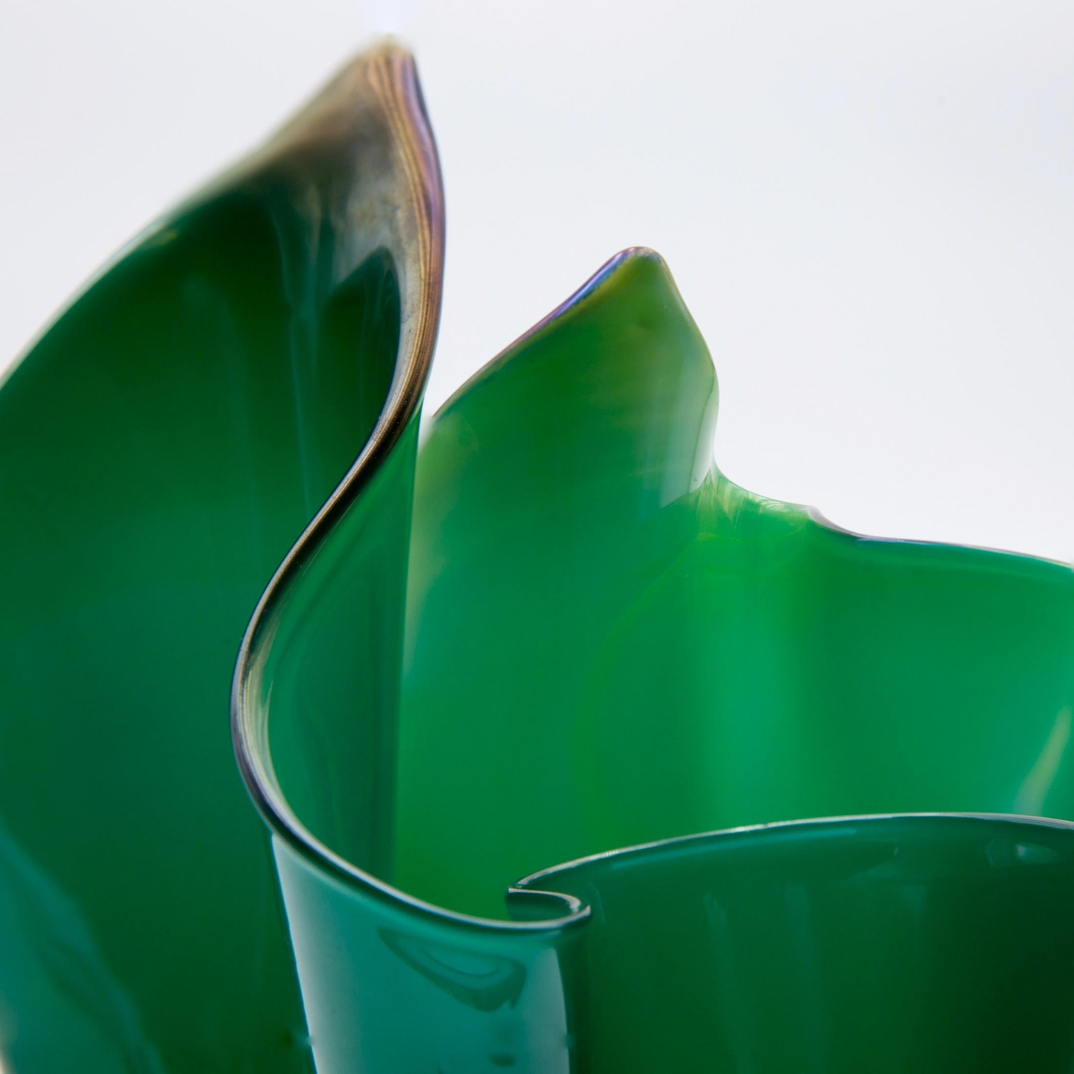 This is a vintage, circa 1950 fazzoletto (handkerchief) vase designed by Fulvio Bianconi for Venini Murano in Italy.
The vase is made from green and yellow mouth blown glass.
The shape of old handkerchief vases by Venini is more interesting than