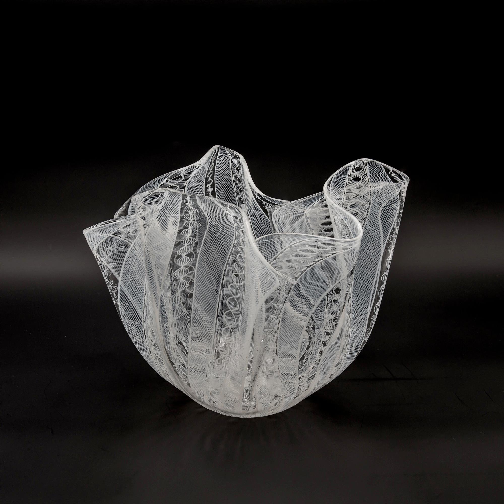 This is a vintage circa 1950 fazzoletto (handkerchief) vase designed by Fulvio Bianconi for Venini Murano in Italy.
The vase is made from transparent glass inserted by Zanfirico canes of white glass
The shape of old handkerchiefs vases by Venini