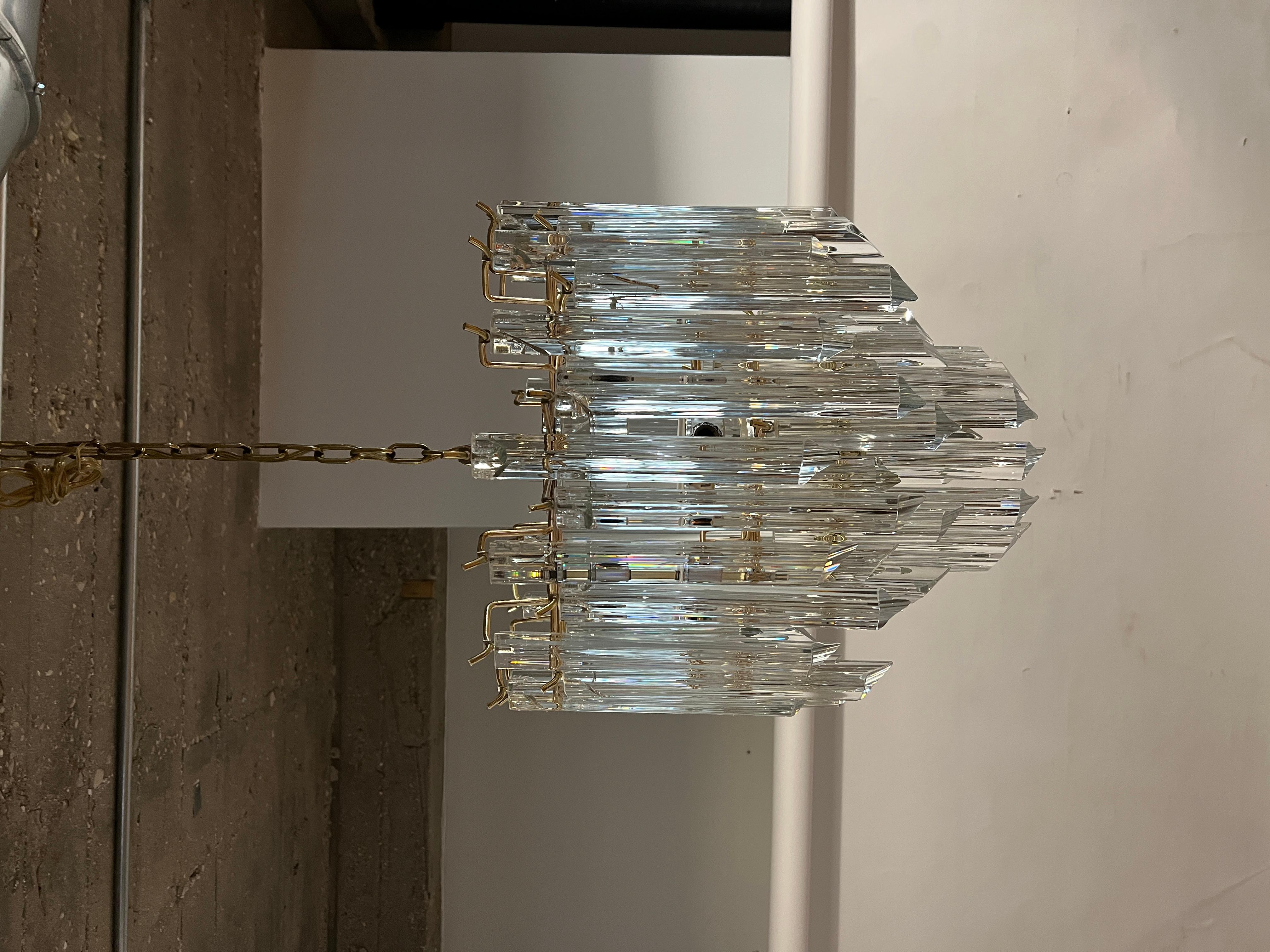 Vintage Venini Murano Triedri Glass Prism Chandelier on a brass skeleton. Chandelier designed to stack two layers of 10