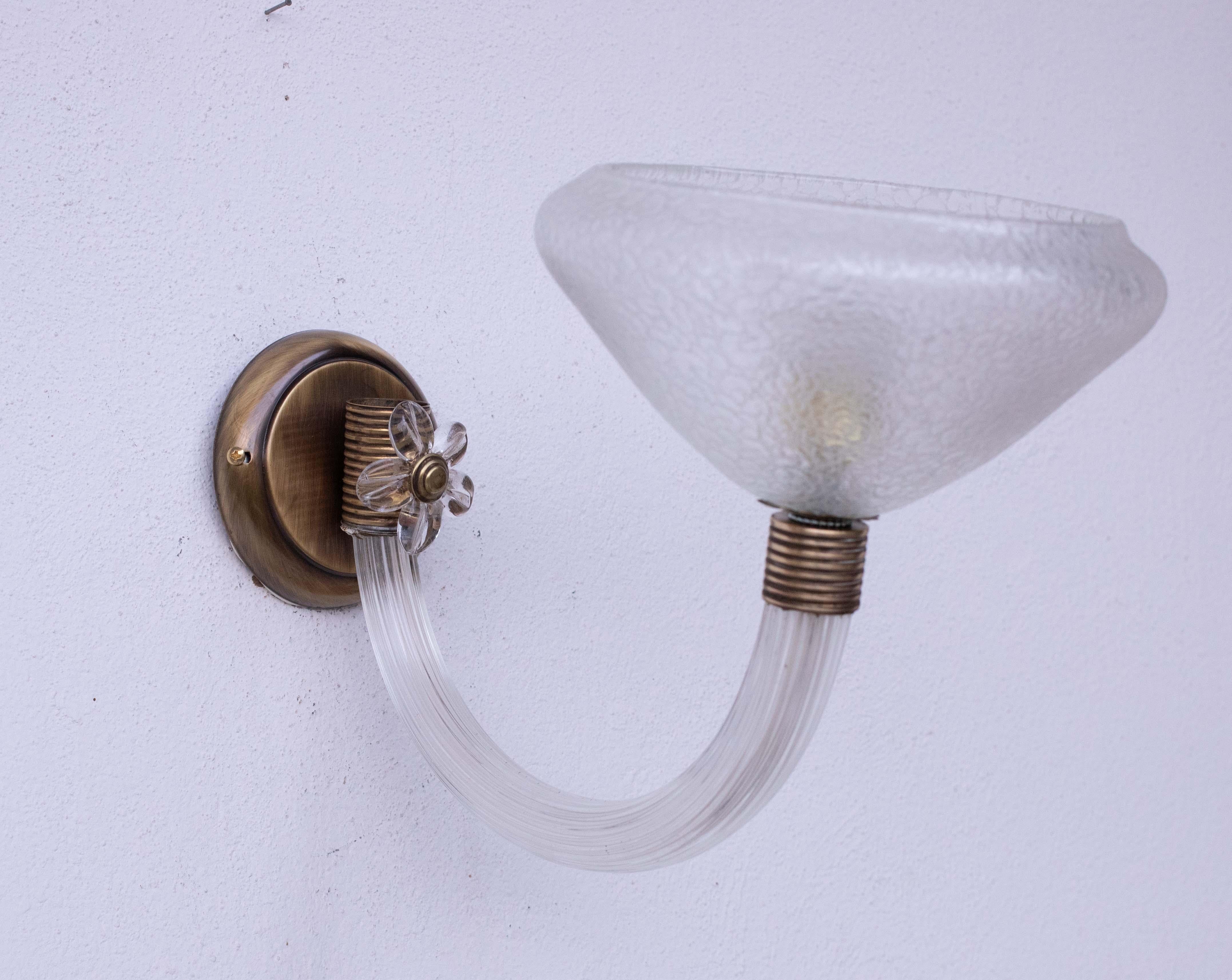 Gorgeous Murano glass wall lamp attributed to the Venini glassworks.

Period of production, circa 1960.

The light is formed by a Murano glass bowl, and a flower is staked on the structure.

The back base is made of steel, the glass and arm
