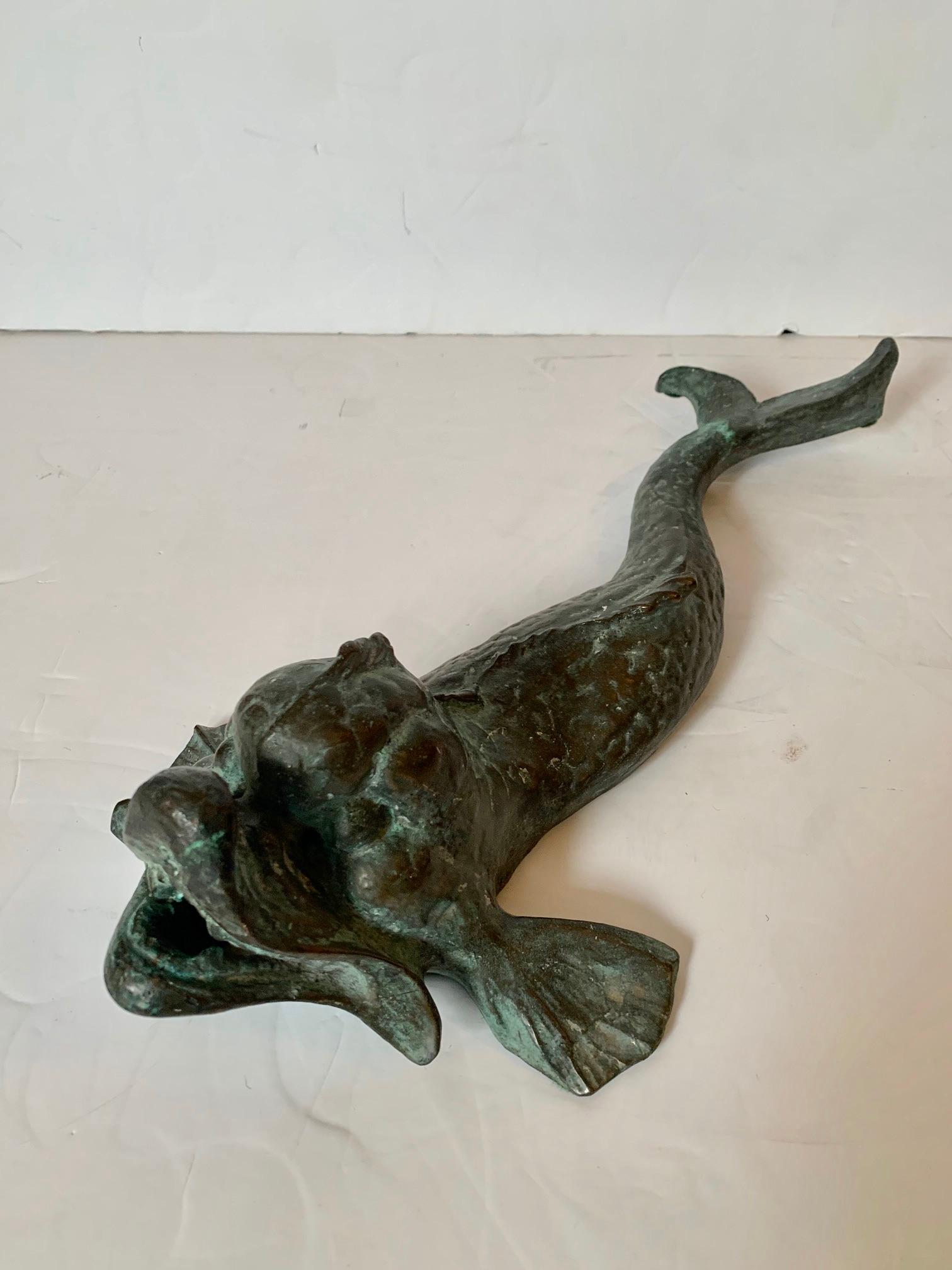 Vintage bronze dolphin sculpture with beautiful verdigris patina and stylized form.