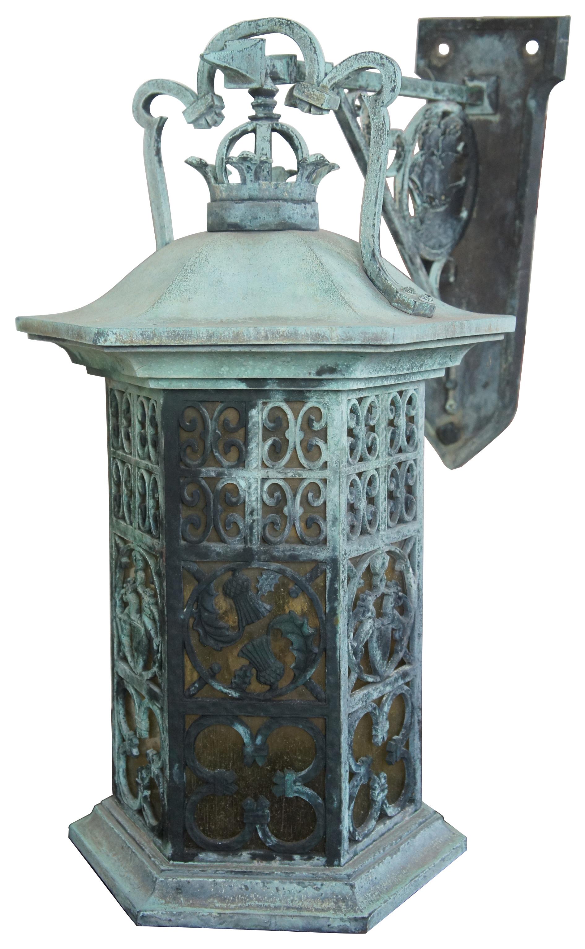 Iron lantern wall sconce. Features a nautical theme with a ship on the wall plaque or crane and heraldic coat of arms, thistles and ornate detail on the lantern. This piece comes from one of the first homes built in oakwood, Ohio by Harry I