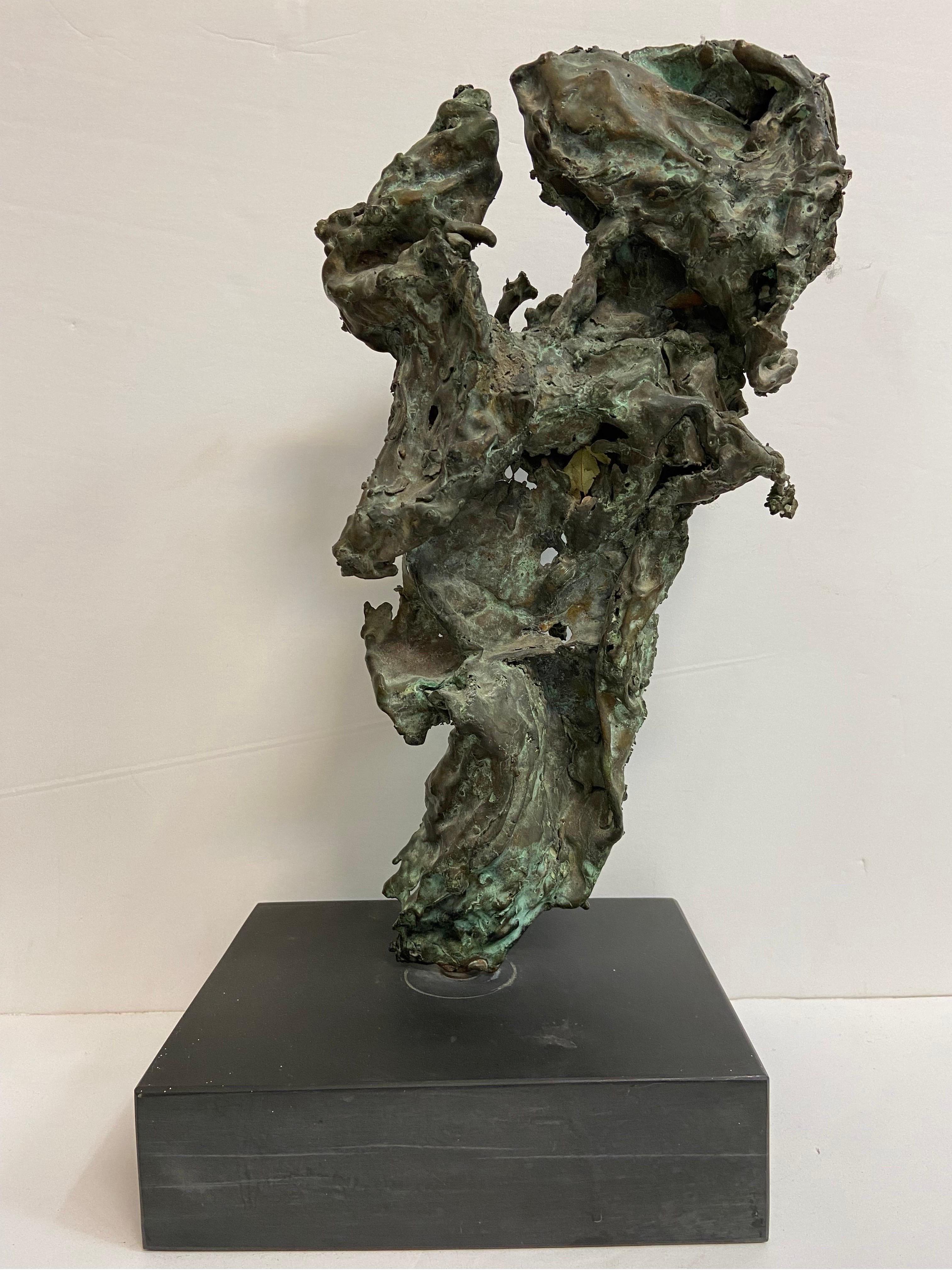 A large and vintage, circa 1960's, verdigris patina brutalist style large bronze sculpture on a base. The sculpture evokes a sense of movement and freedom, captured in a moment of time. The base itself measures approximately 9
