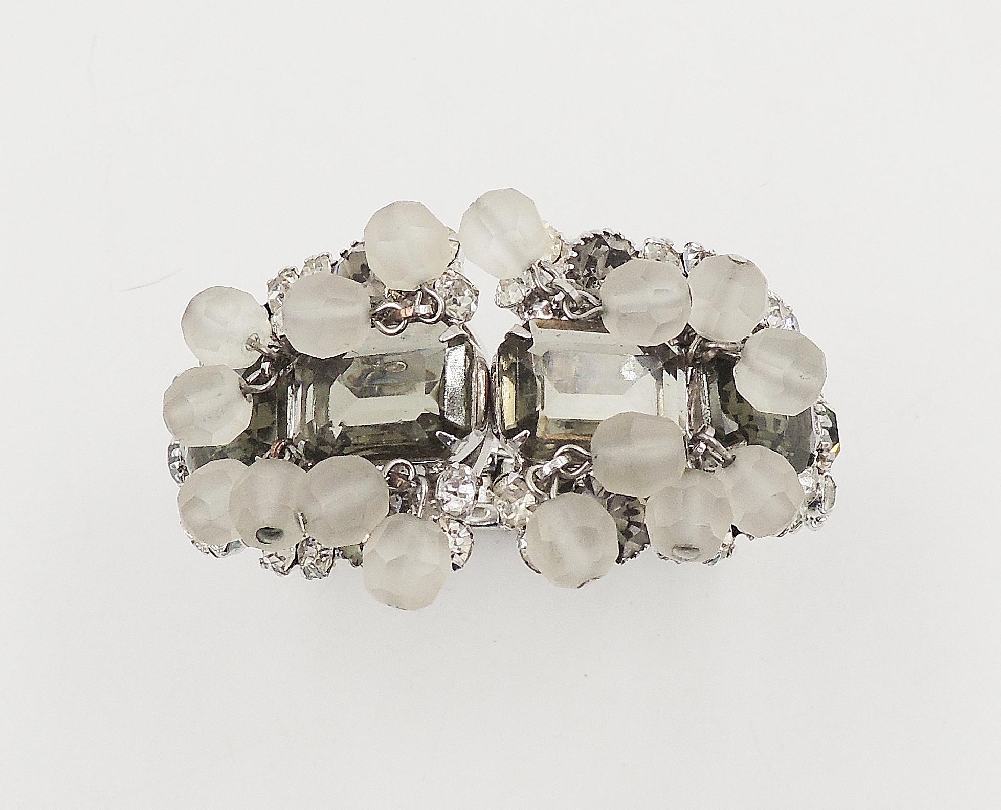 1960s silvertone hinged clamper bracelet with emerald-cut faux black diamond and round paste accents and frosted beads. Unsigned. Verified DeLizza & Elster. Interior, 6 3/4 inches circumference. Overall measures: 2 7/8 inches by 2 3/4 inches by 1