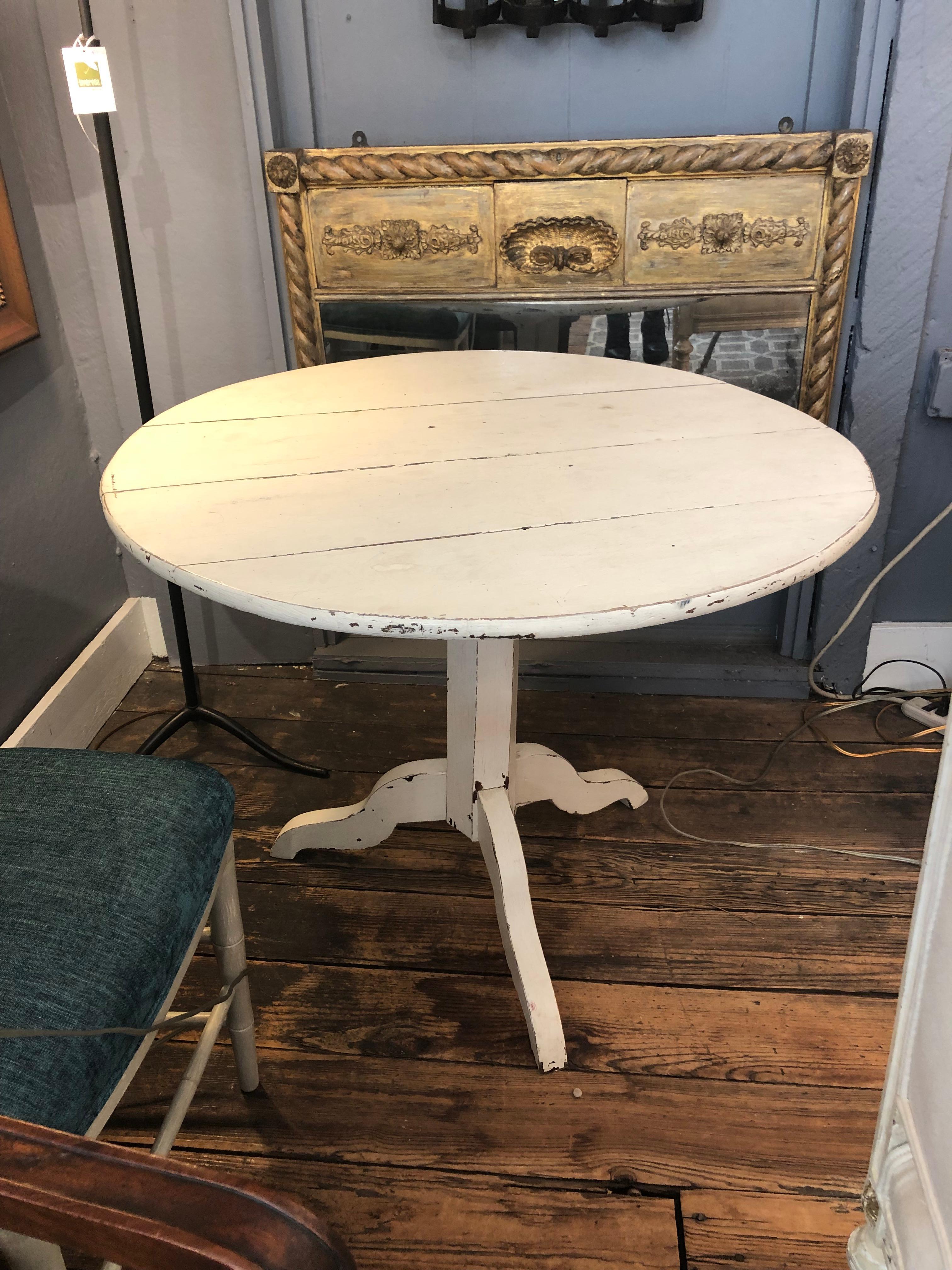 Rustic creamy white painted wood Vermont tilt top round dining table.  Perfect size for breakfast table.  45.5 h when in up position