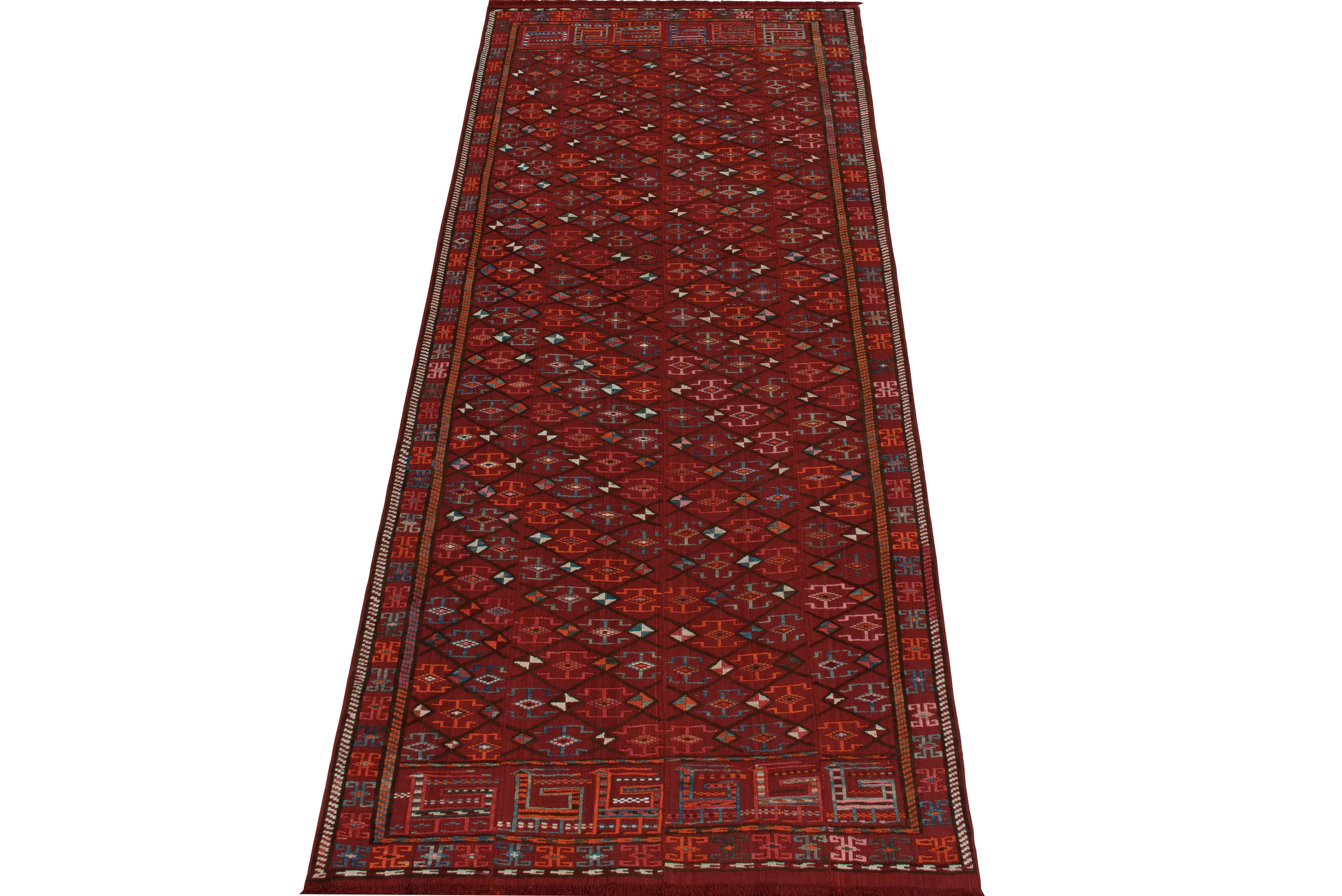 Handwoven in wool from Persia originating between 1950-1960, a 4x8 vintage Verneh kilim enjoying richness and subtle textural elements in play with repetition. The masterpiece relishes an alluring colourway with luxe red playing with deep & blue