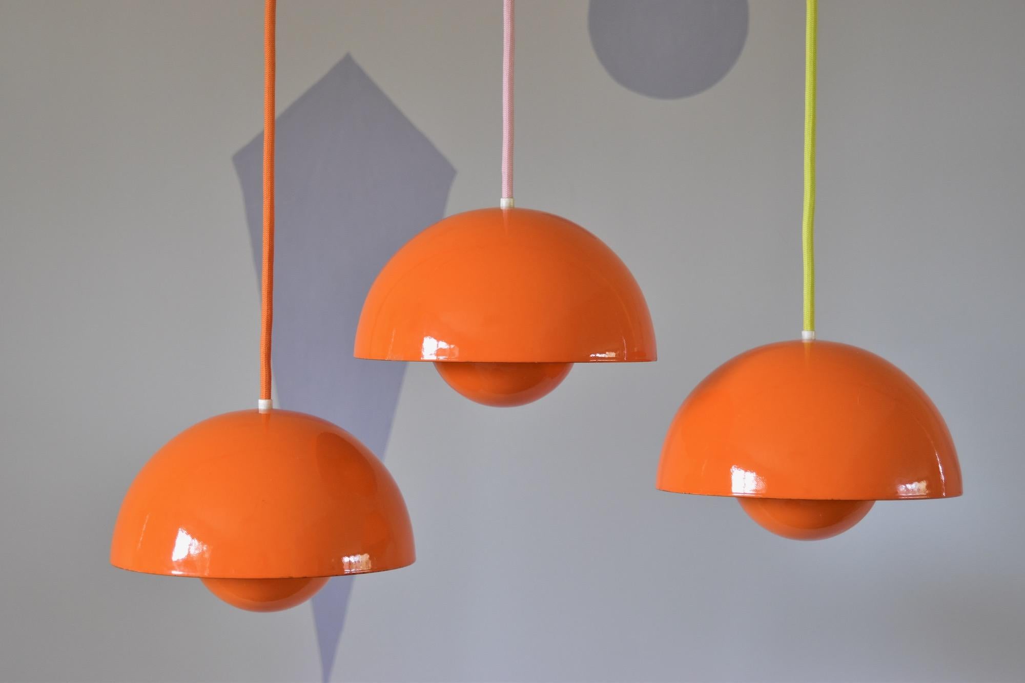 Nice vintage orange enamel flowerpot pendant lamp design Verner Panton in 1968 produced by Louis Poulsen, Made in Denmark. The enameled metal version is no more in production. The lamp is in good condition. No parts missing, with new orange fabric