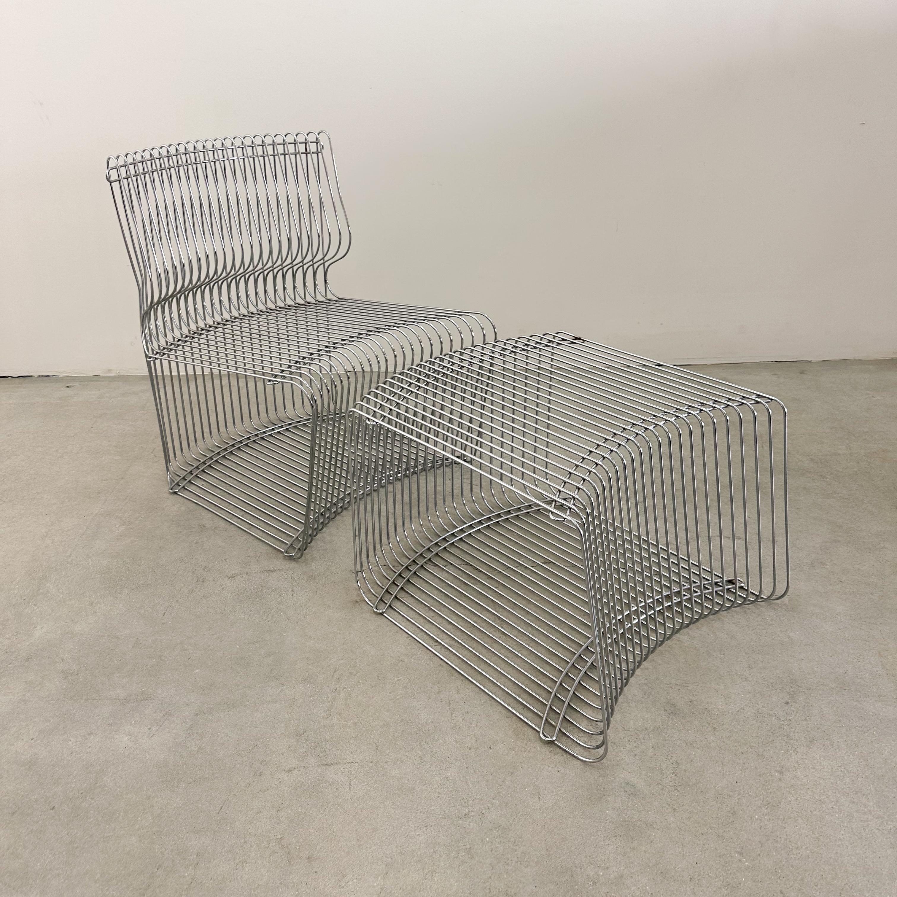This iconic Verner Panton Pantonova lounge chair and ottoman, designed in the 1970s, is a stunning example of Mid-Century Modern innovation. Crafted from polished stainless steel, its sculptural, open-frame design makes it a statement piece for both