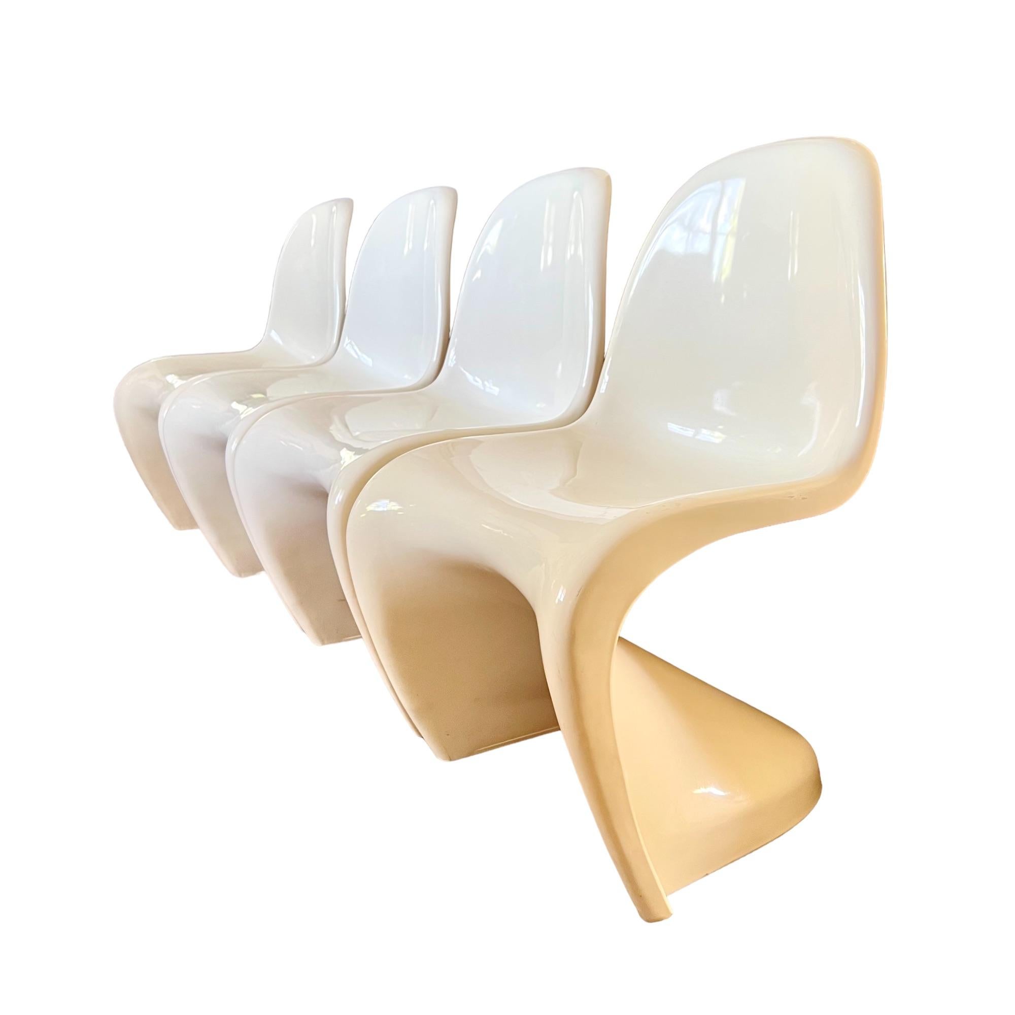 A vintage set of four molded plastic stacking 'S' chairs, originally created by Verner Panton for Vitra in the 1960's. Single form cantilevered design in shiny gloss cream finish.

Dimensions: 19