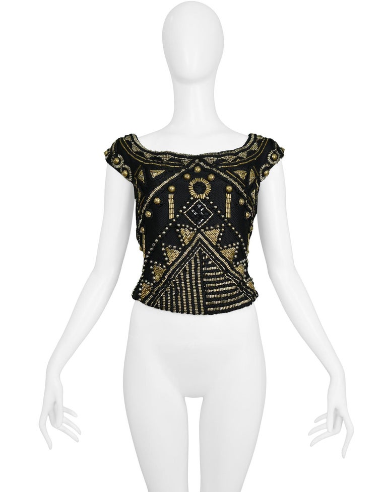 Vintage Gianni Versace heavily embellished brass colored beaded top that falls off the shoulder into a cap sleeve and side zip closure. Collection 1990.

Excellent Vintage Condition.

Size 42

Measurements : Measured Flat Not Stretched:  
Shoulder
