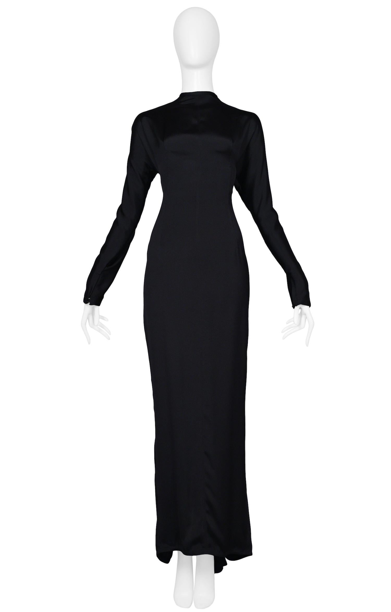 Vintage Gianni Versace black jersey long sleeve gown featuring an ornate silver and black beaded cutout back in a quintessential art deco design and a godet at the center back hem. Circa 1986-87.

Excellent Vintage Condition.

Size