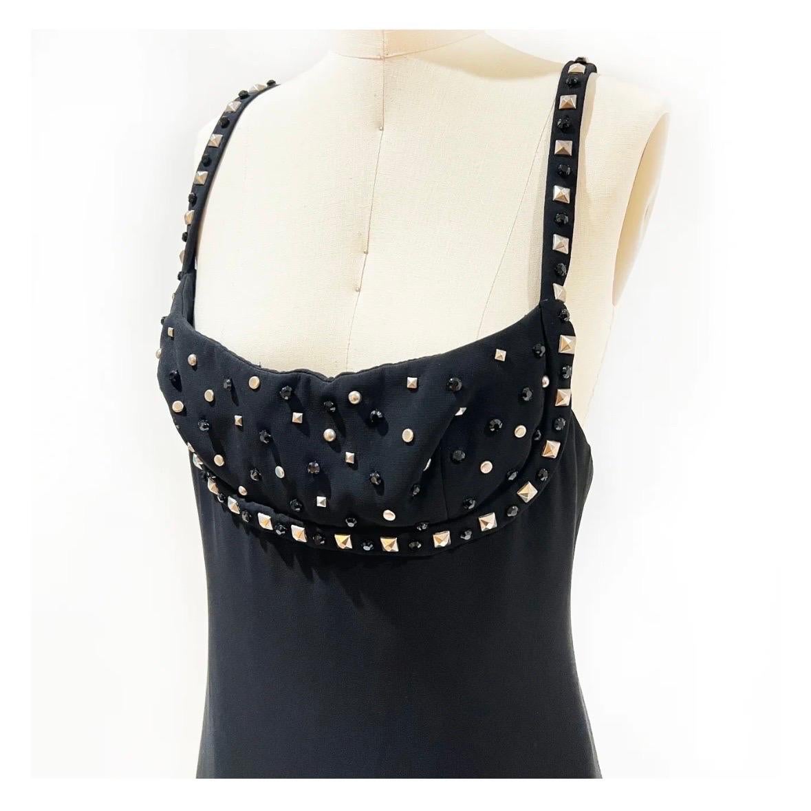 Vintage black studded gown by Gianni Versace Couture
Fall/Winter 1998 Ready-to-Wear
Made in Italy
Black 
Silver-metal stud embellished bust and straps 
Black crystals intermixed with studs 
Back zipper closure 
Attached mesh bodysuit lining inside