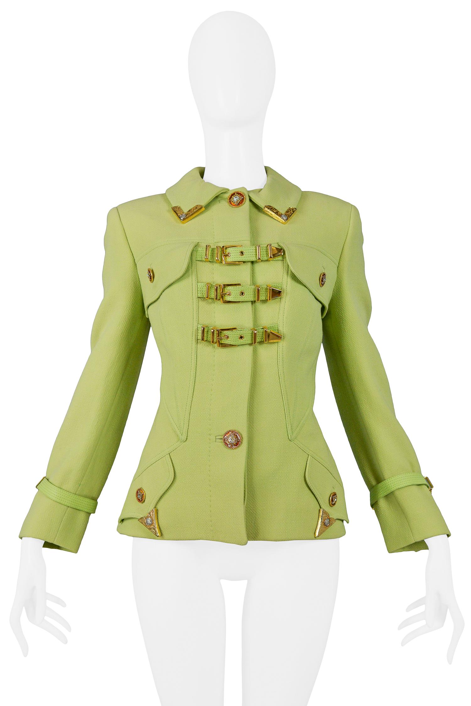 Iconic vintage Gianni Versace chartreuse green bondage jacket. The jacket features  gold-tone bondage buckles at center front and cuffs, enameled rhinestone buttons, and western inspired corner tips at collar and pockets. From the 1992 collection.