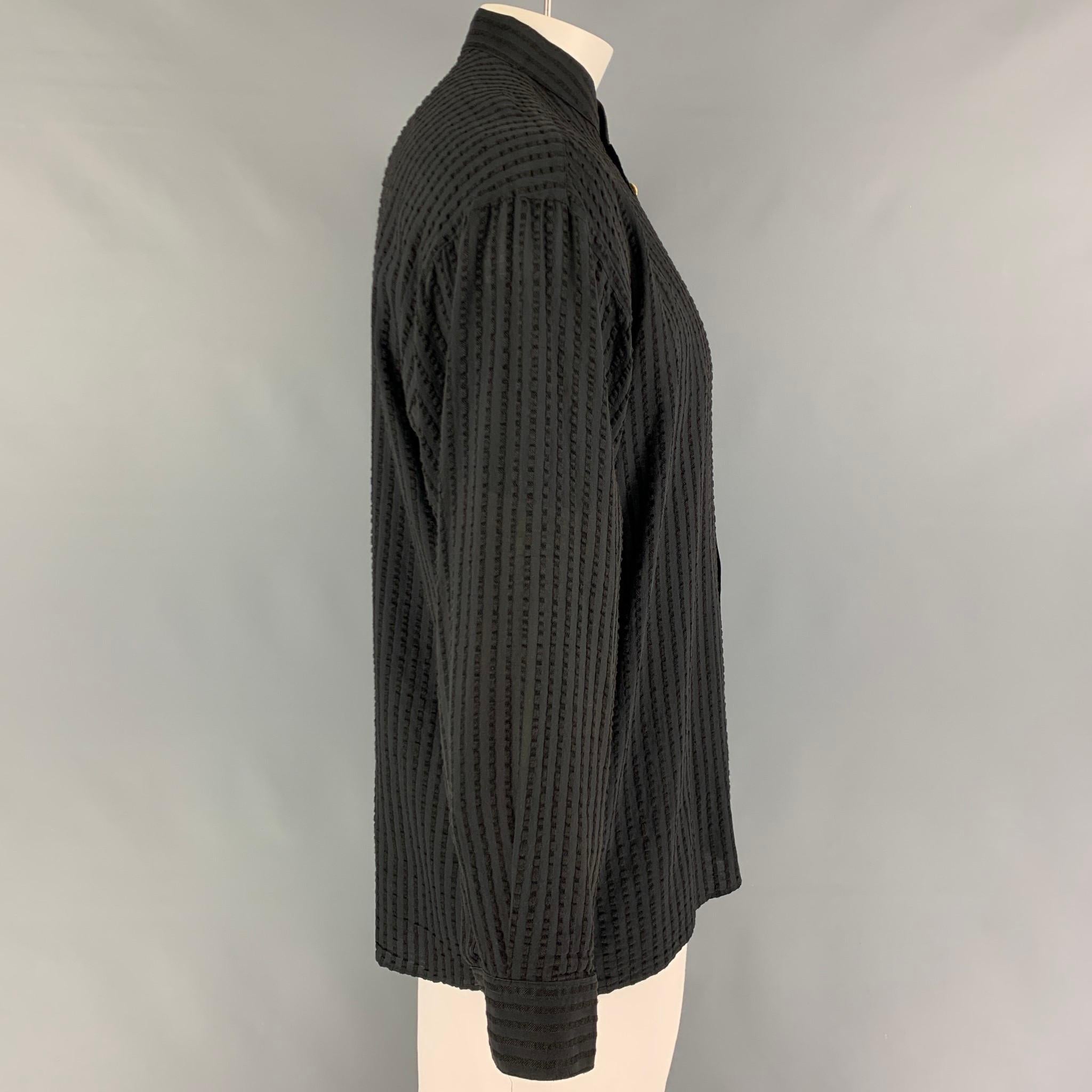 Vintage VERSACE CLASSIC long sleeve shirt comes in a black ribbed material featuring a nehru collar, gold tone buttons, and a button up closure. 

Very Good Pre-Owned Condition. Fabric tag removed.
Marked: Size tag removed

Measurements:

Shoulder: