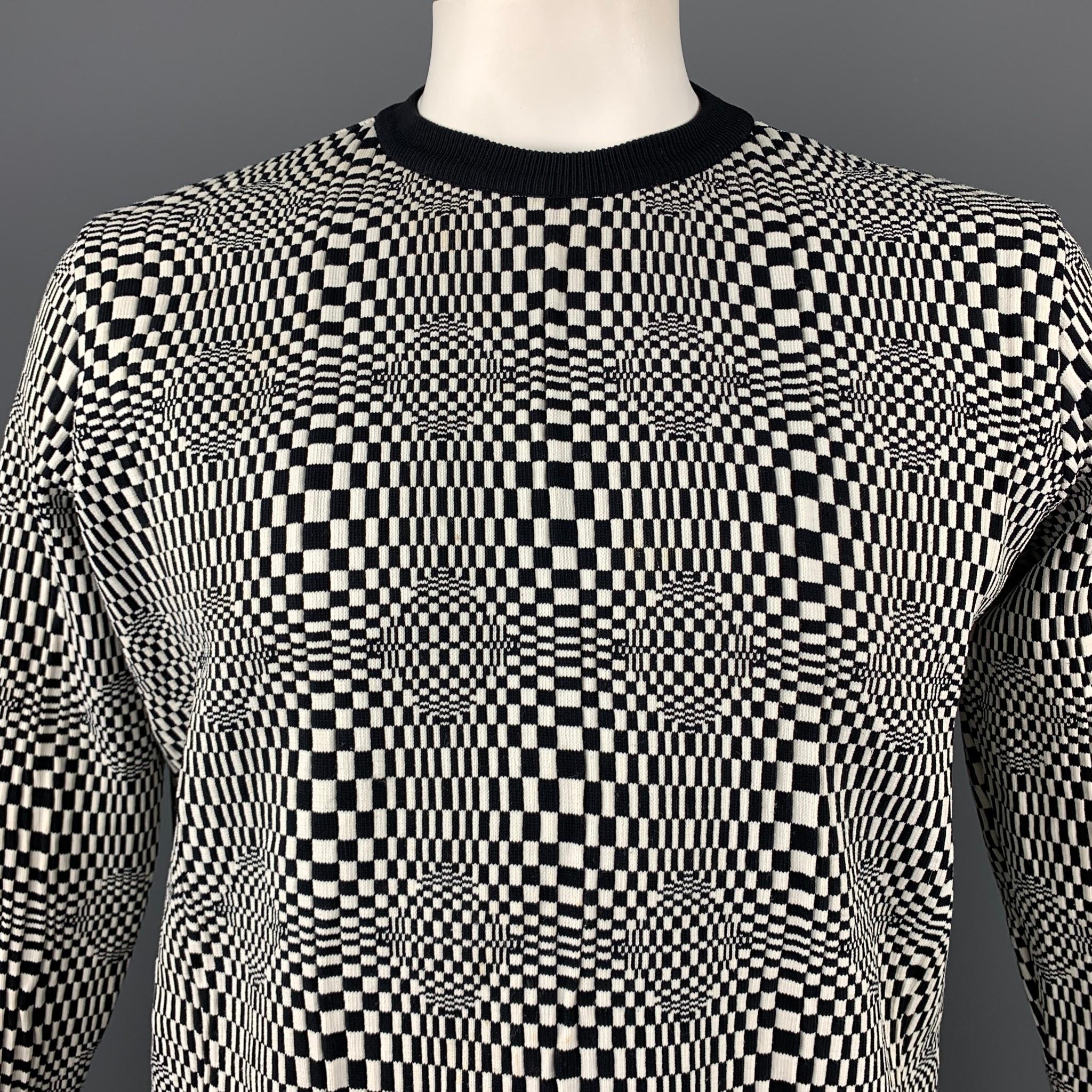 Vintage VERSACE CLASSIC pullover comes in a black & white geometric nylon featuring a ribbed hem and a crew-neck. Minor wear. Made in Italy.

Good Pre-Owned Condition.
Marked: XL

Measurements:

Shoulder: 19 in. 
Chest: 42 in. 
Sleeve: 25 in.