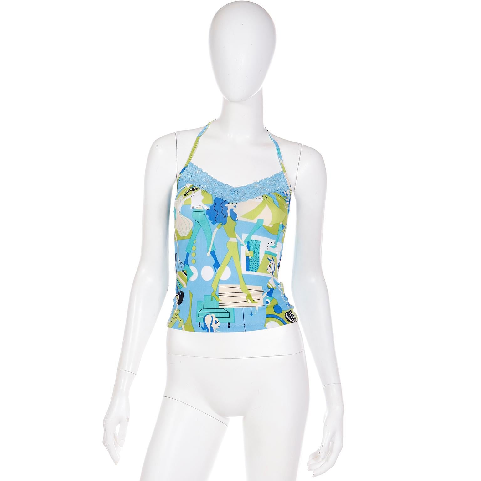 We love this rare vintage 1990's Versace Jeans Couture colorful halter top! What makes this top so special is the novelty print fabric featuring women shopping! The print is in pretty shades of blue and green with blue lace trim. There are straps to
