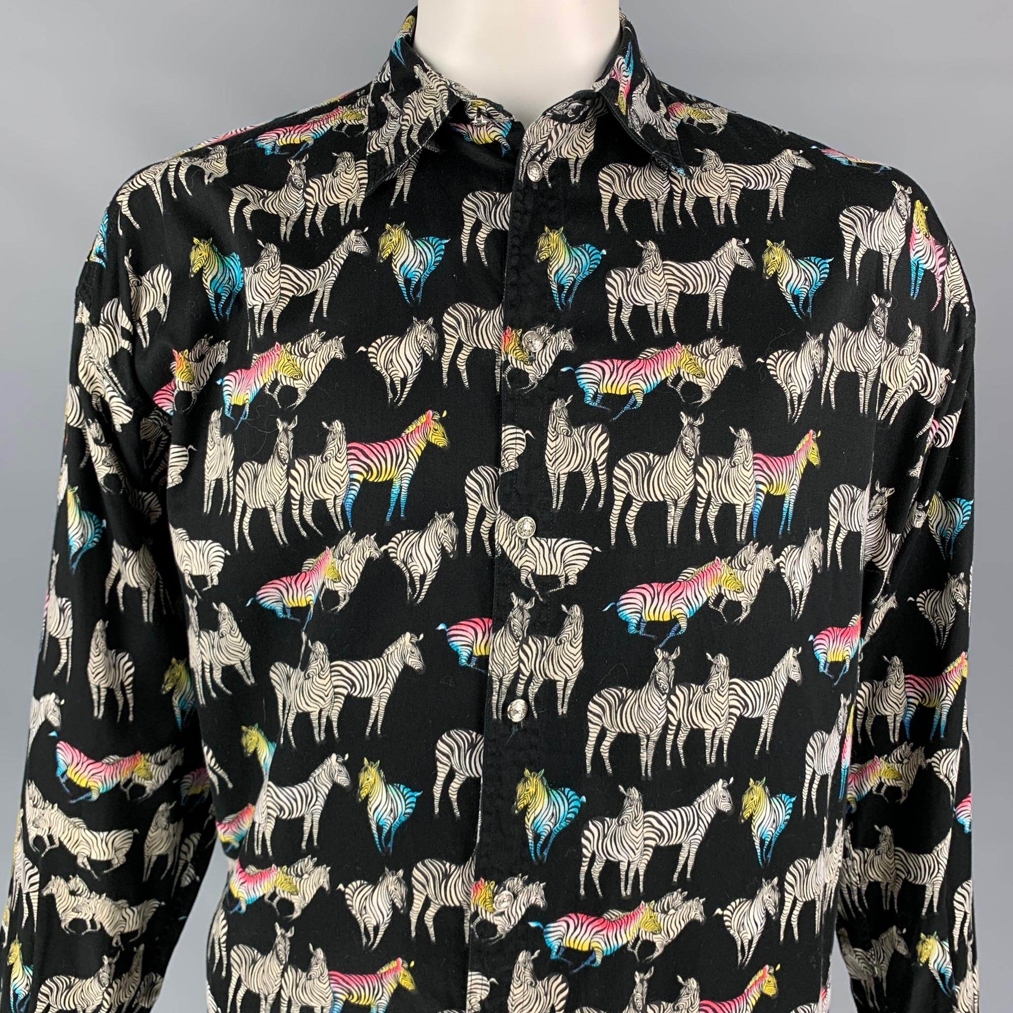 Vintage VERSACE JEANS COUTURE long sleeve shirt comes in a black & white zebra print cotton featuring a spread collar and a silver tone medusa head button up closure. Made in Italy.

Very Good Pre-Owned Condition.
Marked: L

Measurements:

Shoulder: