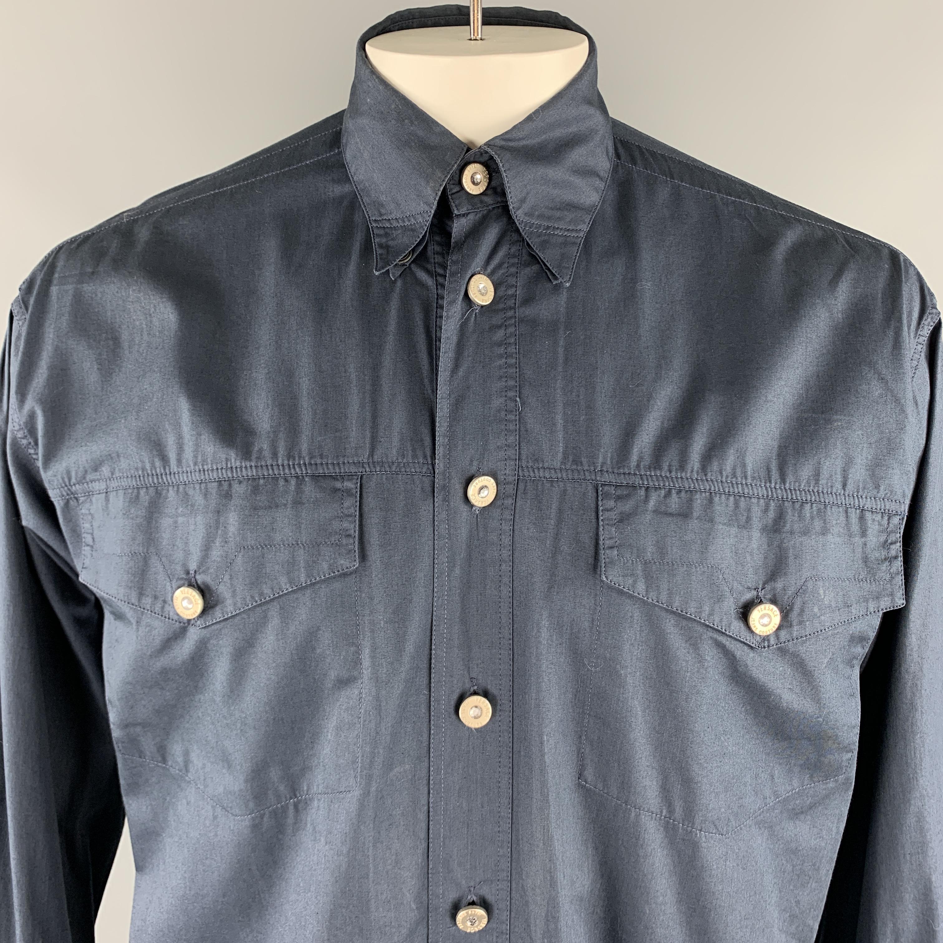 Vintage VERSACE JEANS COUTURE long sleeve shirt comes in a solid navy cotton material, with silver tone metal embellished buttons, patch pockets, and buttoned cuffs, button down. Made in Italy. 

Very Good Pre-Owned Condition.
Marked: 15 1/2