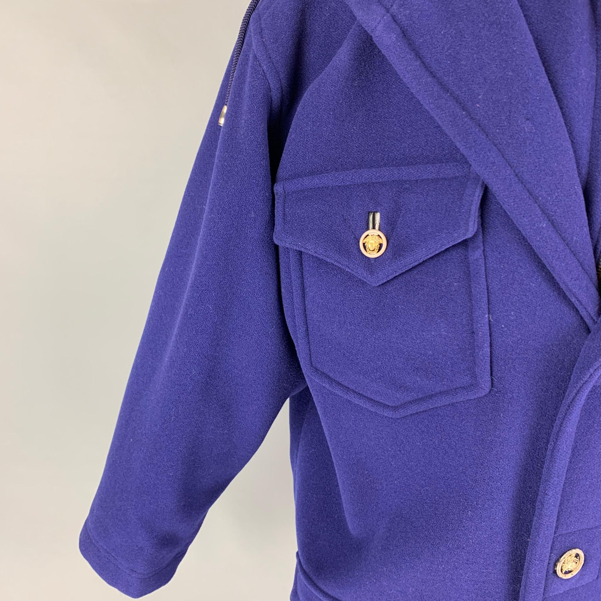 Vintage VERSACE JEANS COUTURE coat comes in a purple wool featuring a double layer design, metal medusa head buttons, hooded, patch pockets, oversized fit, and a zip & buttoned closure. Made in Italy. 

Good Pre-Owned Condition.
Marked: