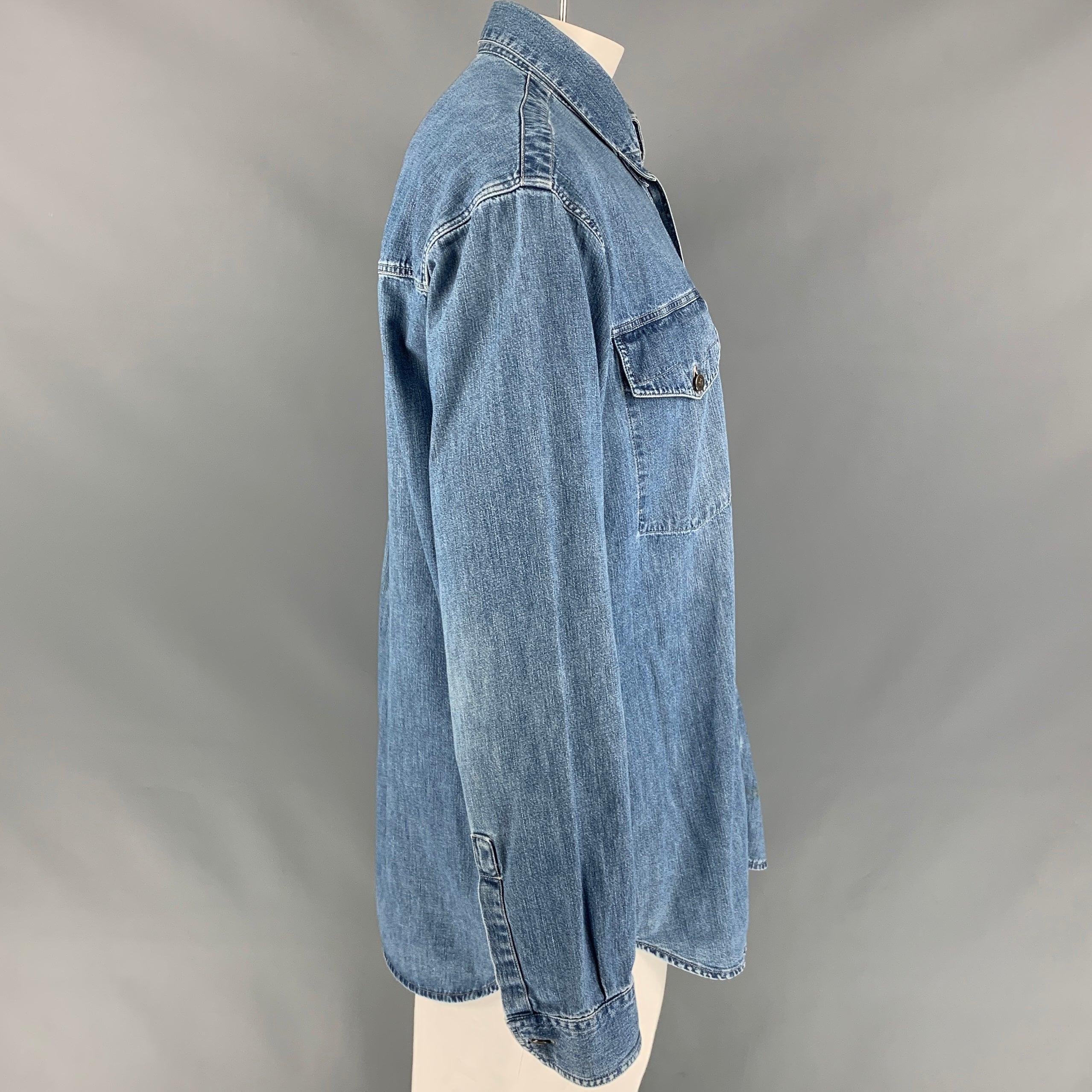 Vintage VERSACE JEANS COUTURE long sleeve shirt comes in a blue wash denim featuring contrast stitching, medusa head buttons, pointed collar, and a button up closure. Made in Italy.
Good
Pre-Owned Condition. Minor marks at front.  

Marked:   XL