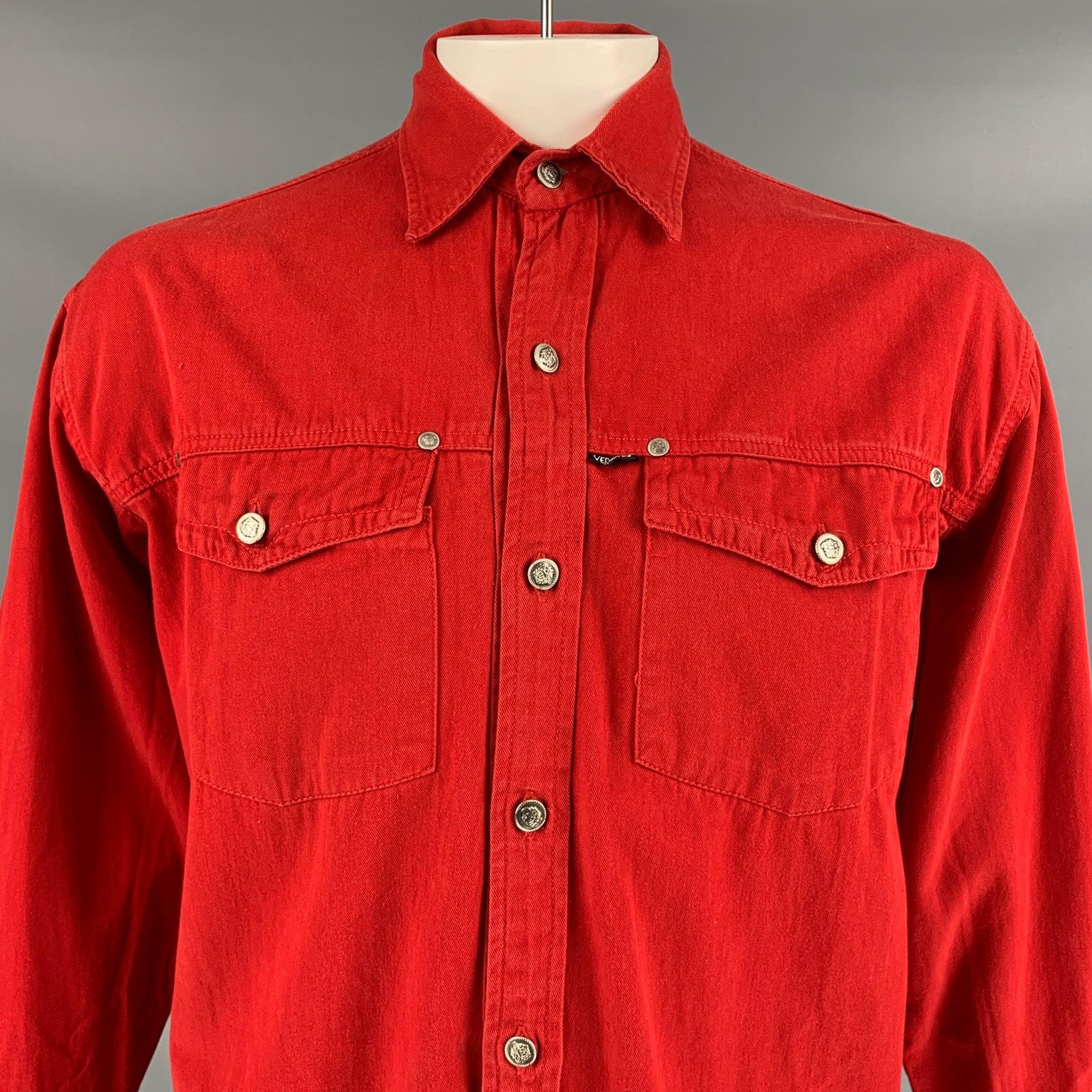 Vintage VERSACE JEANS COUTURE long sleeve shirt comes in a red cotton featuring silver tone medusa head buttons, front flap pockets, pointed collar, and a button up closure. Made in Italy.
 Very Good
 Pre-Owned Condition. 
 

 Marked:  XXL  
 

