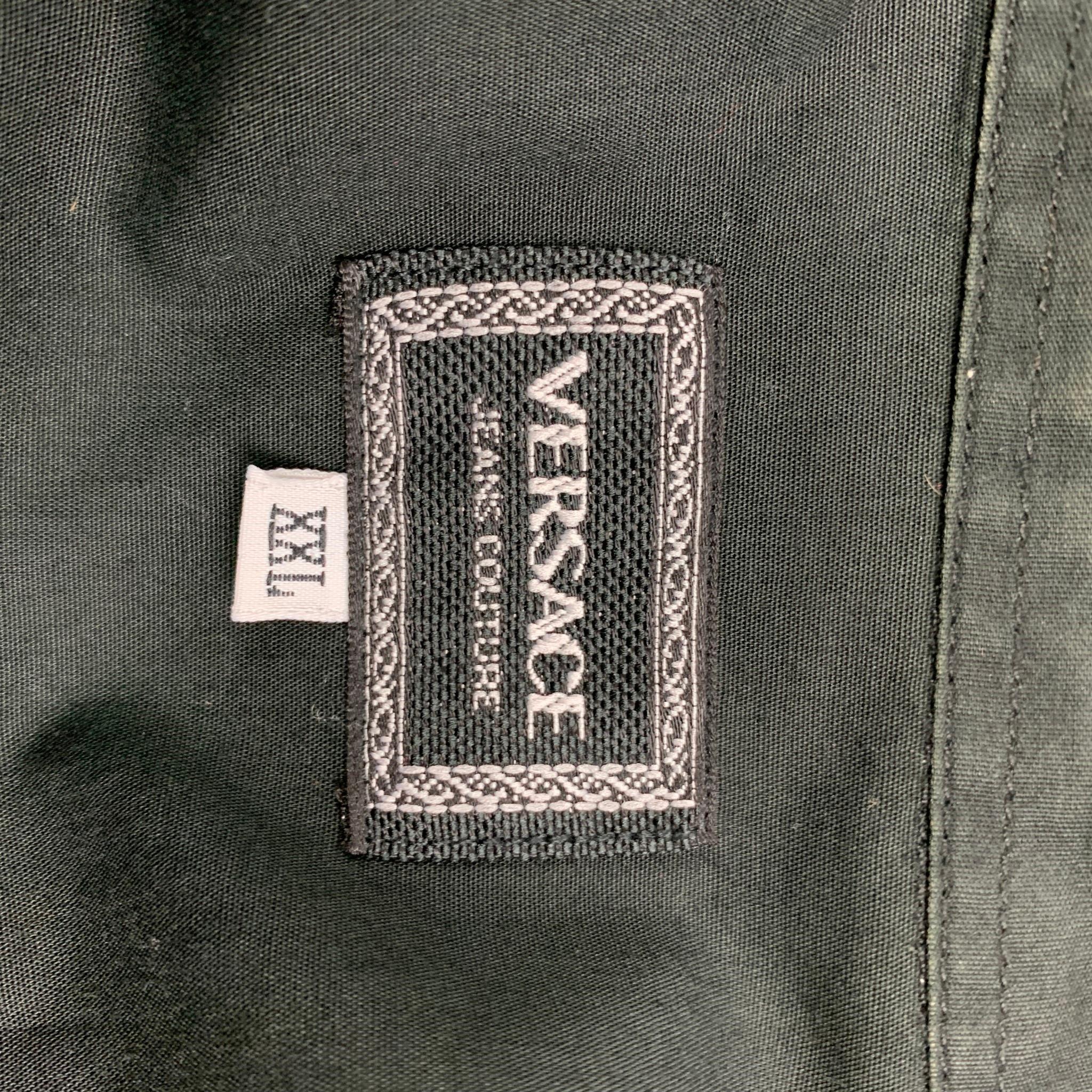 Vintage VERSACE JEANS COUTURE long sleeve shirt comes in a black cotton featuring a button down collar, silver tone medusa buttons, front pockets, and a button up closure. Made in Italy. 

Very Good Pre-Owned Condition.
Marked: