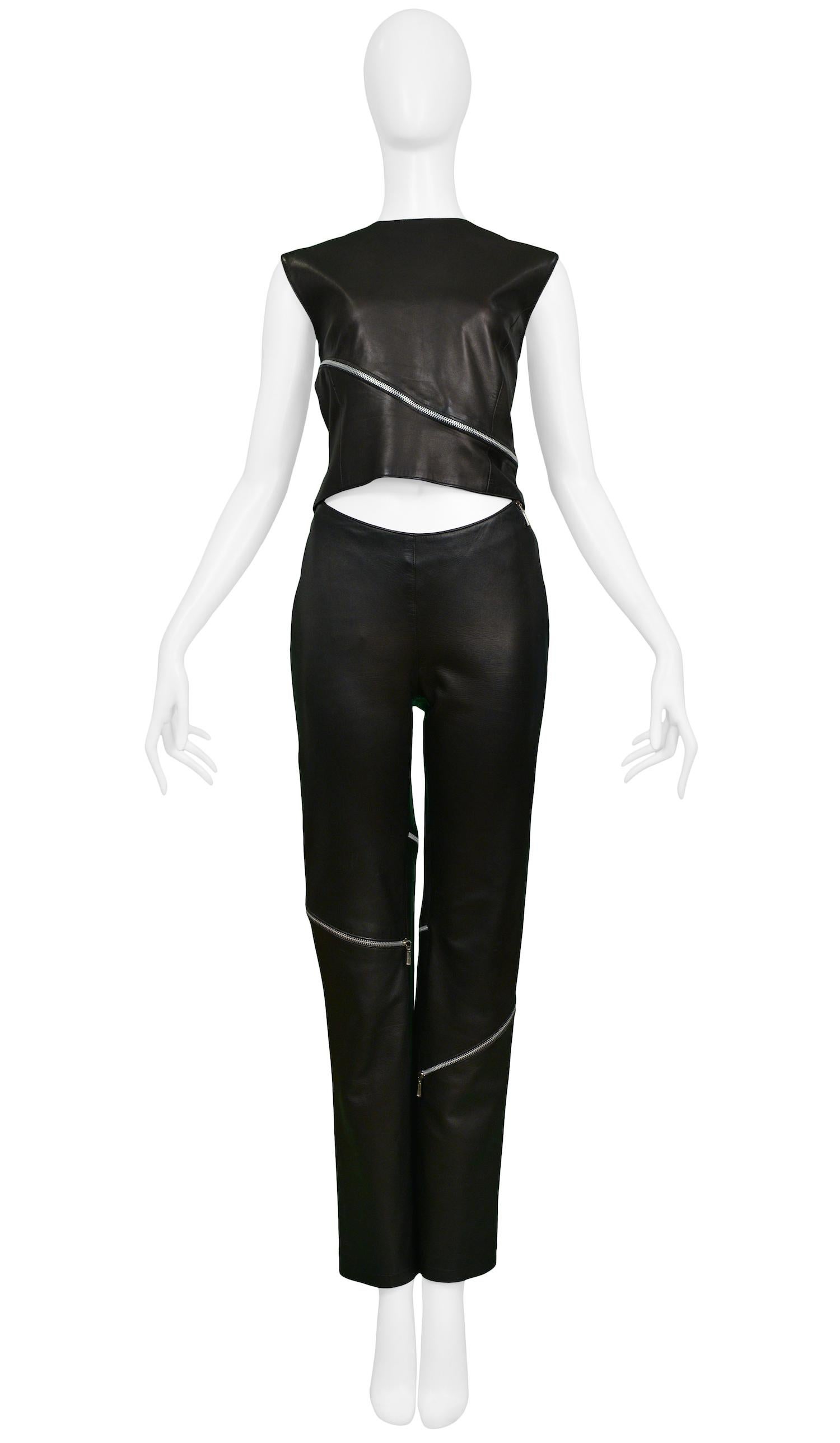 Black lambskin leather pants paired with crew neck leather top. Wrap around zipper detail on both pieces.

Excellent Condition.

Size 42

Top Measurements:
Shoulder 16