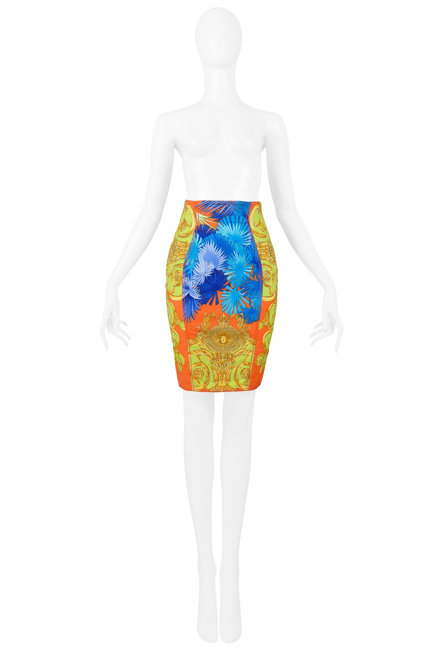 Vintage Versace orange, cobalt blue, and neon green cotton pencil skirt with palm frond and gold baroque-style print. Circa 1990s.

Excellent Vintage Condition.

Size 38