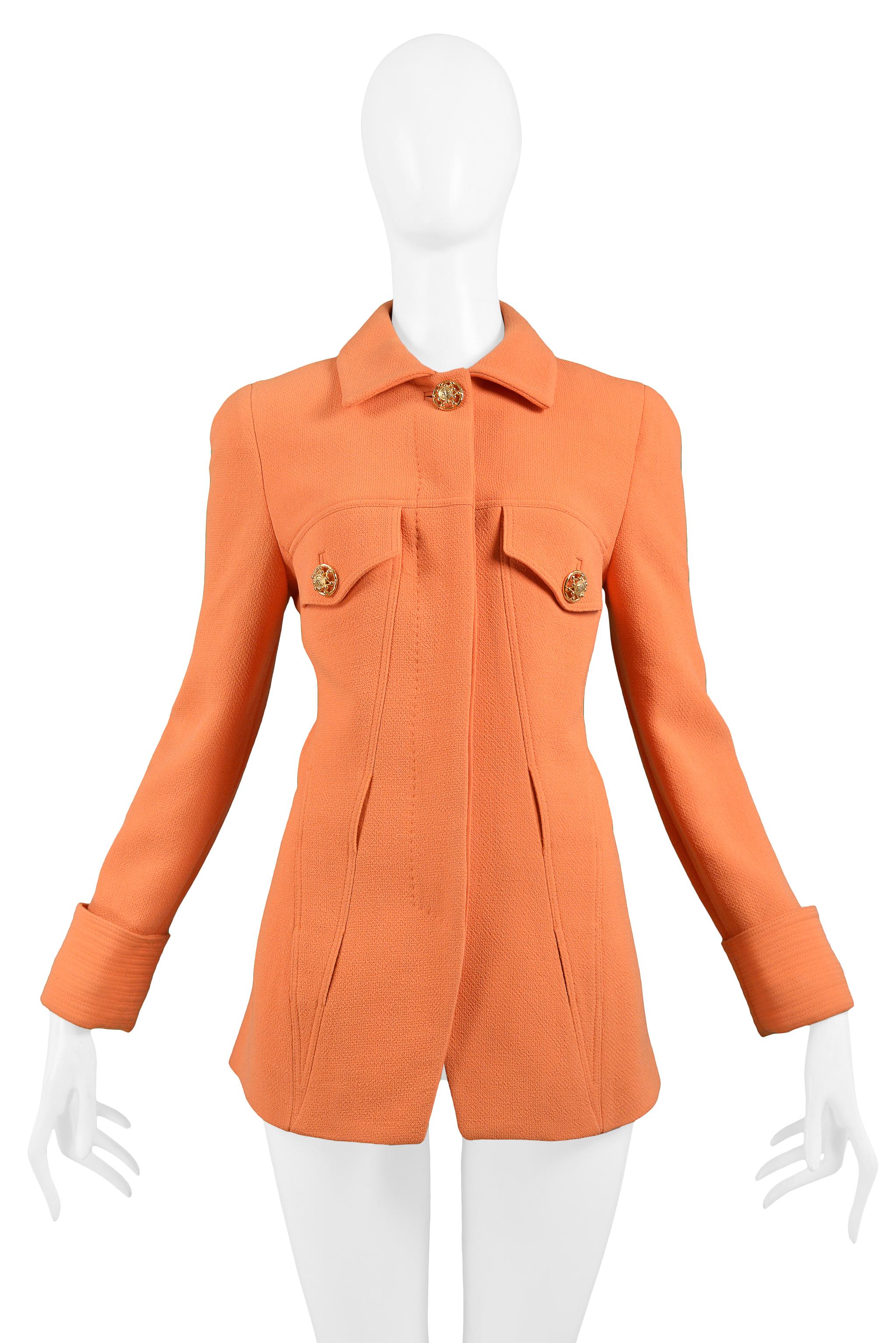 Vintage Gianni Versace coral orange wool blazer jacket with gold-tone Medusa buttons at breast pockets and collar. Features hidden-button closure at center front and double layer belt loops set into the front and back. Collection 1991.

Excellent