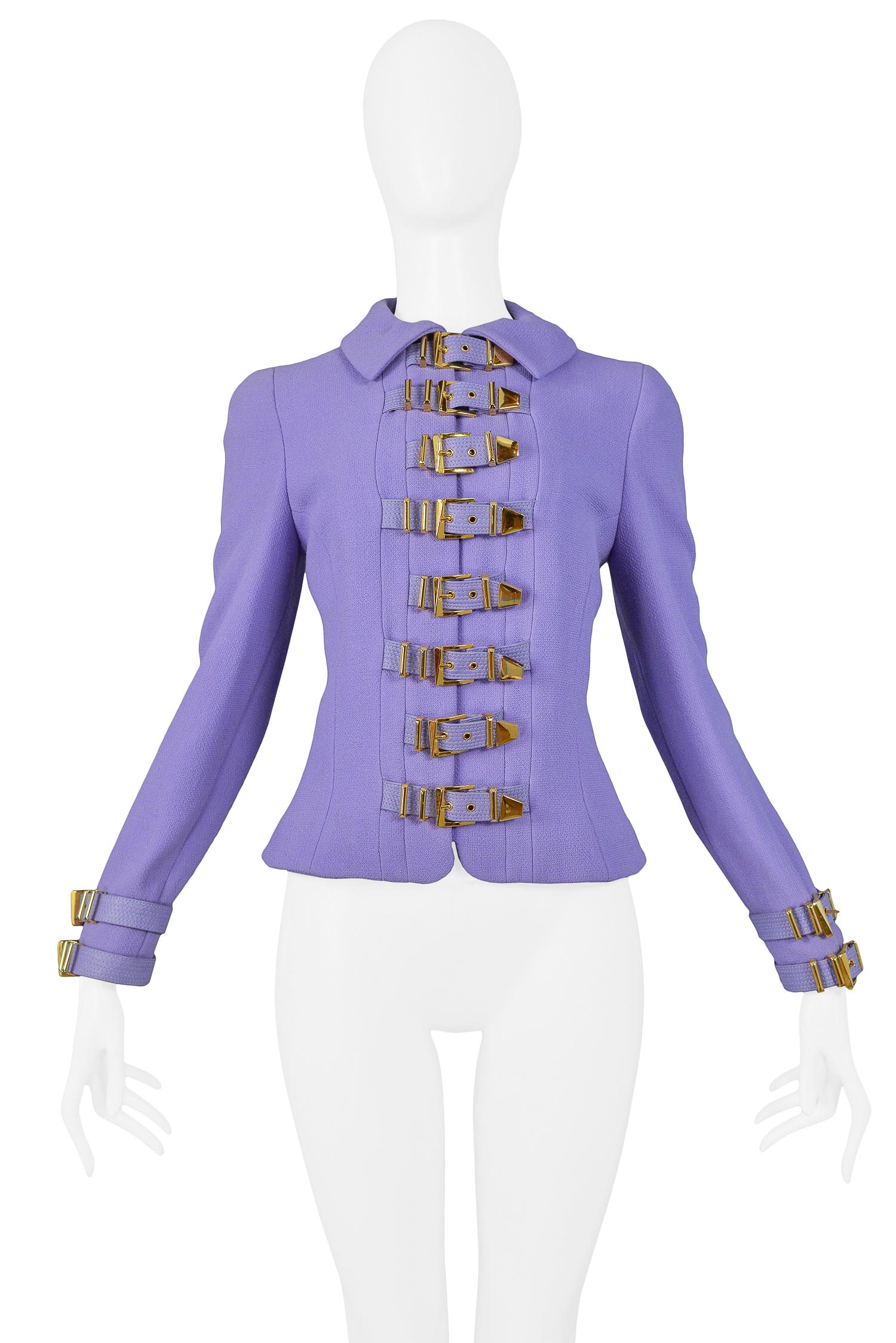 Iconic vintage Gianni Versace periwinkle purple bondage jacket with fold over collar and gold-tone bondage buckles at sleeve cuffs, center front closure, and center back. From the 1992 collection.

Excellent Vintage Condition.

Size 38