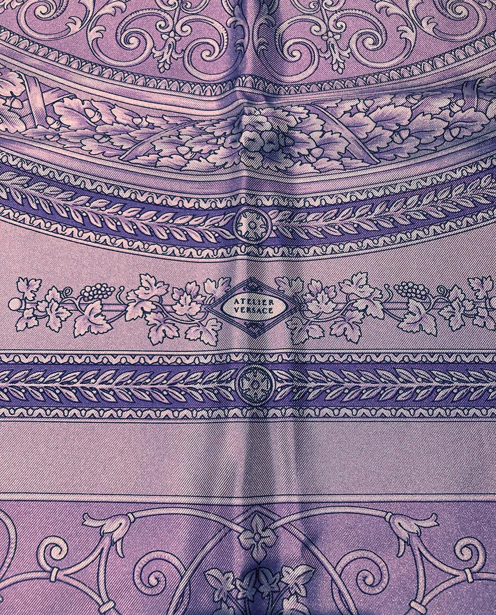 Vintage Versace Purple Silk Scarf in excellent condition. 100% silk, hand rolled hem. tag attached. c1990s. no stains smells or fabric pulls. multi tonal purples with classic versace style filigree and ornate Grecian statue and floral print.