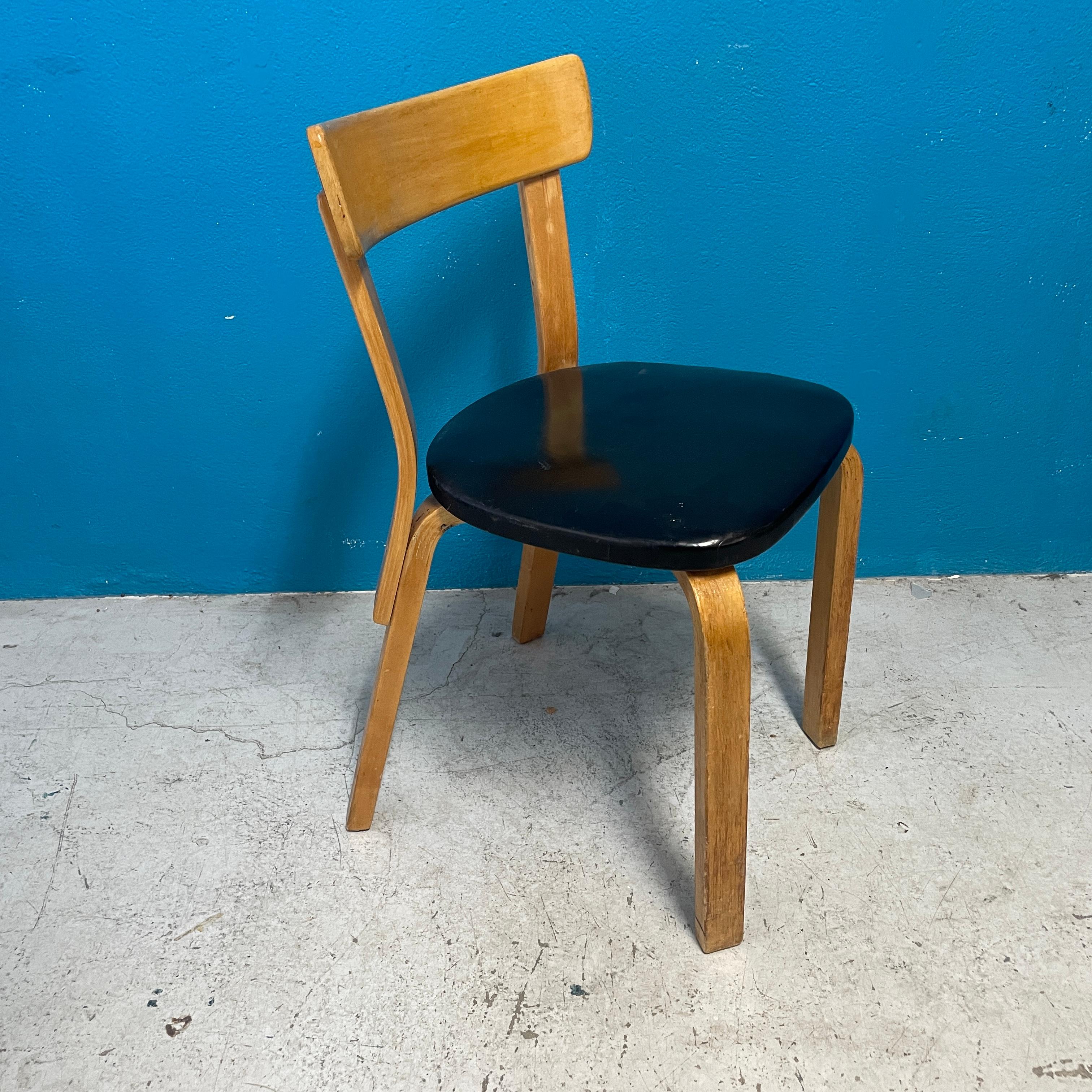 Early version of 69-chair designed by Alvar Aalto. Black faux leather seat upholstery with 