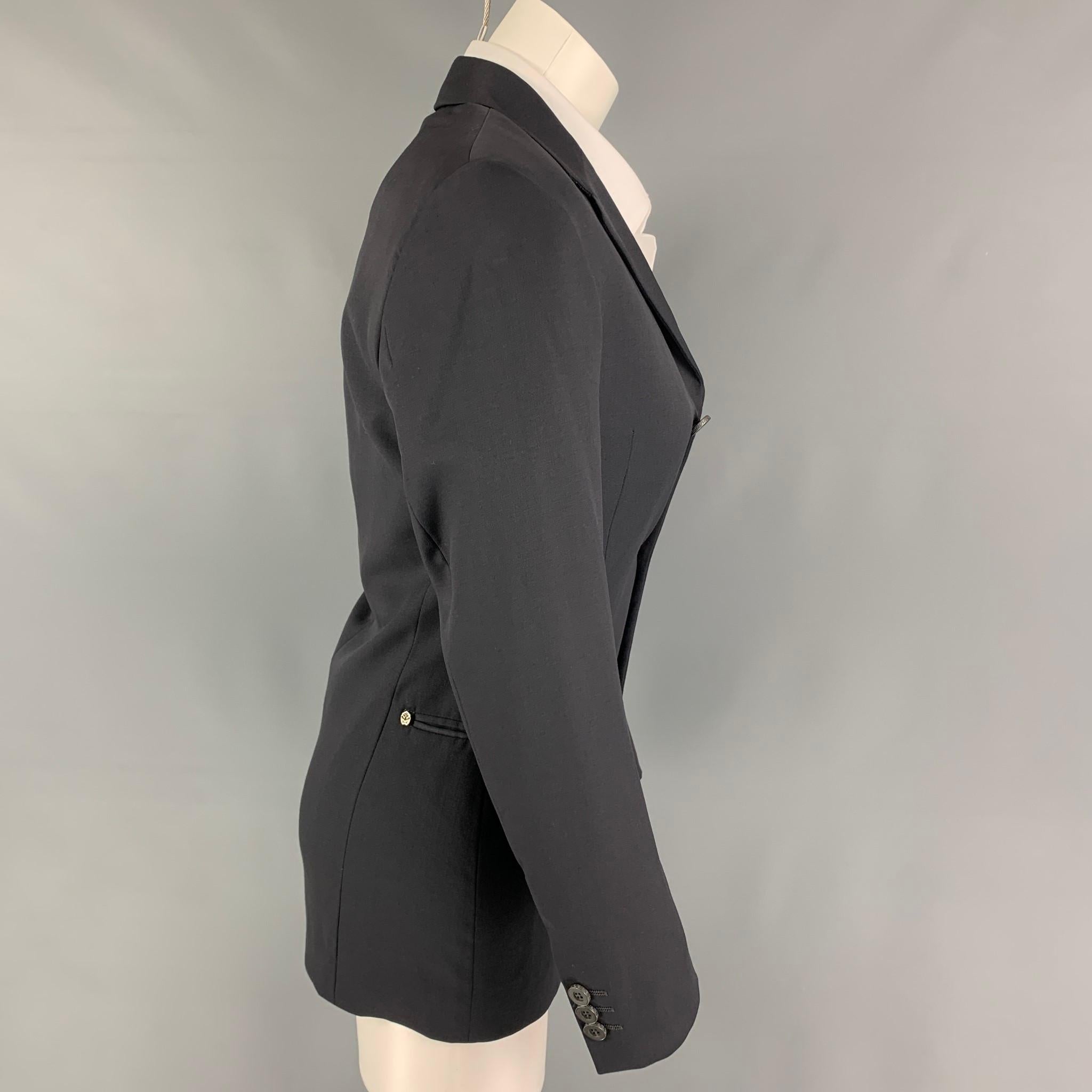 Vintage VERSUS by GIANNI VERSACE sport coat comes in a gray virgin wool with a full liner featuring a notch lapel, slit pockets, shoulder pads, silver tone hardware, and a three button closure. Made in Italy. 

Excellent Pre-Owned Condition.
Marked: