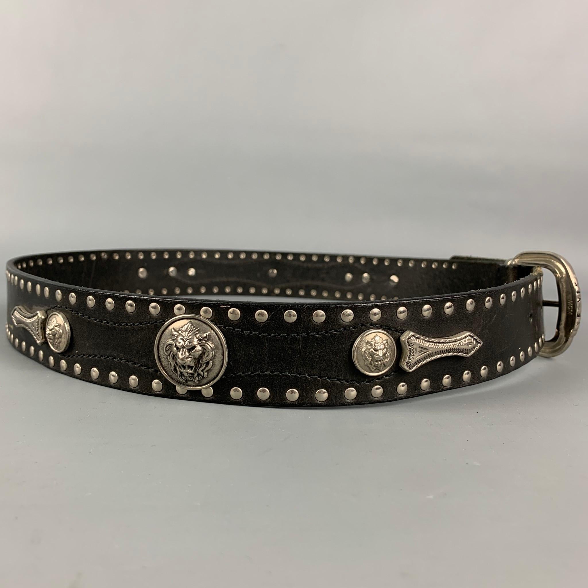 Vintage VERSACE by GIANNI VERSACE belt comes in a black leather with a studded design throughout featuring lion head details and a buckle closure. Made in Italy.

Good Pre-Owned Condition.
Marked: 95/38

Length: 44.5 in.
Width: 1.25 in.
Fits: 35 in.