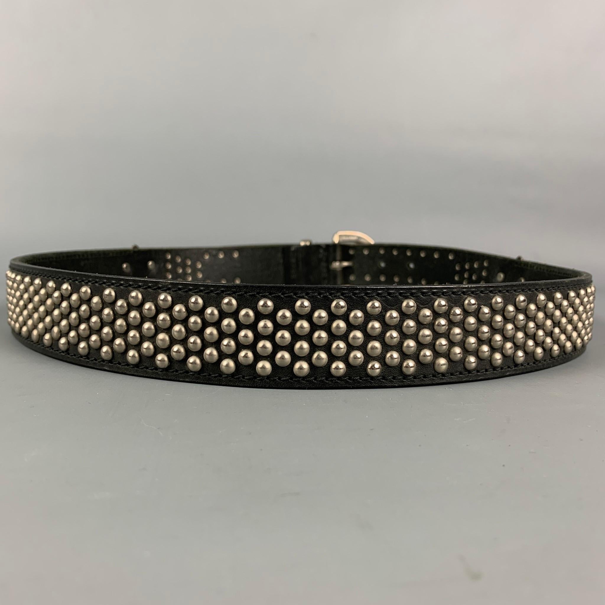 Vintage VERSACE by GIANNI VERSACE belt comes in a black leather with a studded design throughout featuring lion head details and a buckle closure. Made in Italy.

Good Pre-Owned Condition.
Marked: 95/38

Length: 44.5 in.
Width: 1.25 in.
Fits: 35 in.