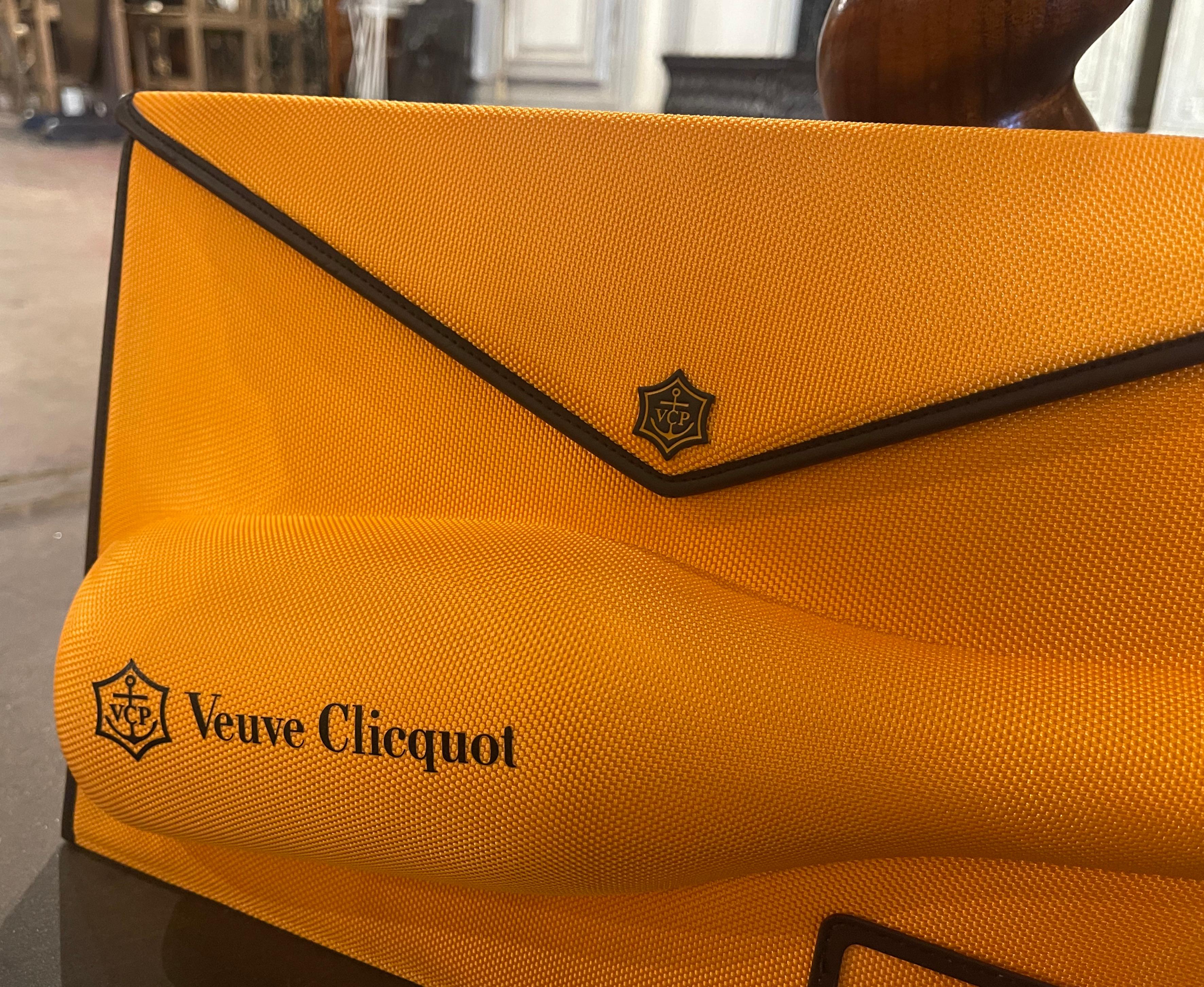 Introducing the captivating Clicquot Clutch an exquisite reinterpretation of the classic envelope purse. This resplendent yellow carrier was crafted in France circa 2010, and is adorned with elegant brown leather piping, which exudes sophistication.