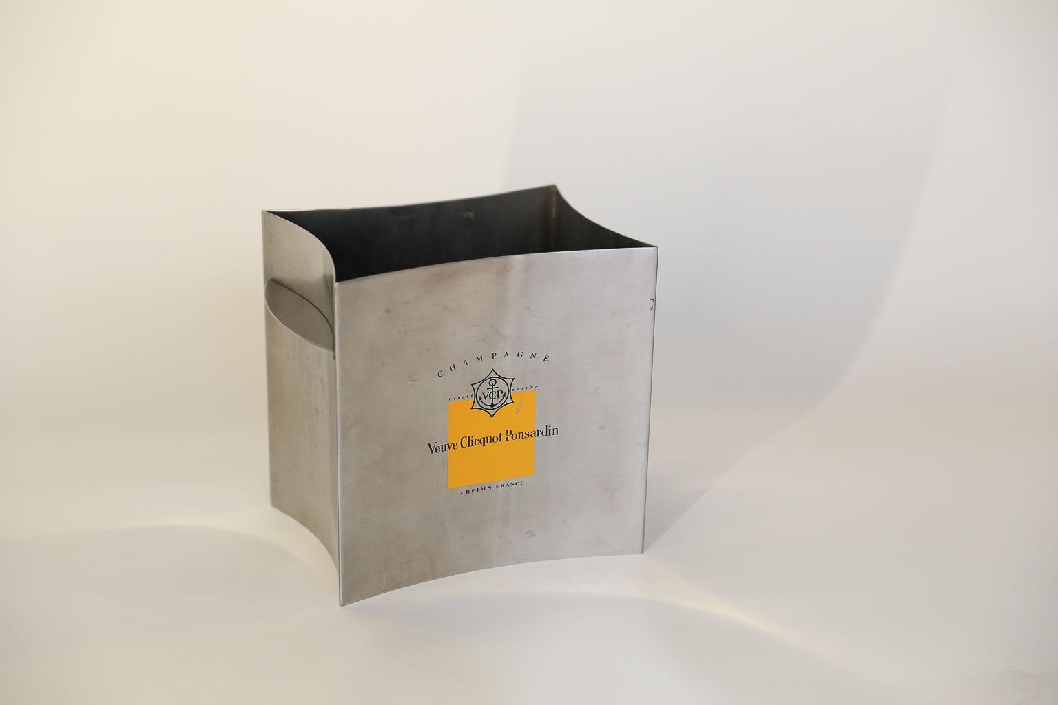 This is a beautiful stainless steel single bottle champagne cooler from the House of Veuve Clicquot bearing the name and insignia of the house. The sleek, angular look and contemporary design of the cooler are the star attractions. The cooler could