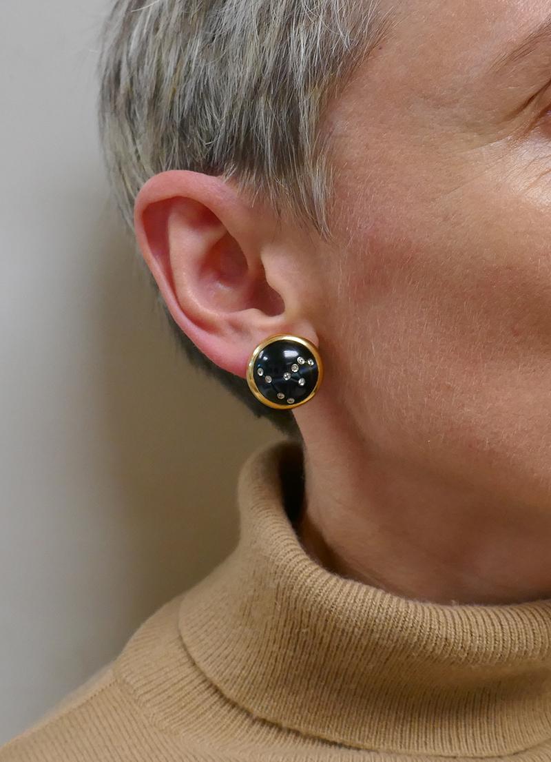 A pair of vintage Vhernier earrings made of 18 karat yellow gold with diamond and black onyx.
The button vintage earrings feature black onyx bezel-set in gold. The diamonds create a Capricorn constellation pattern. There are tiny lines carved in the