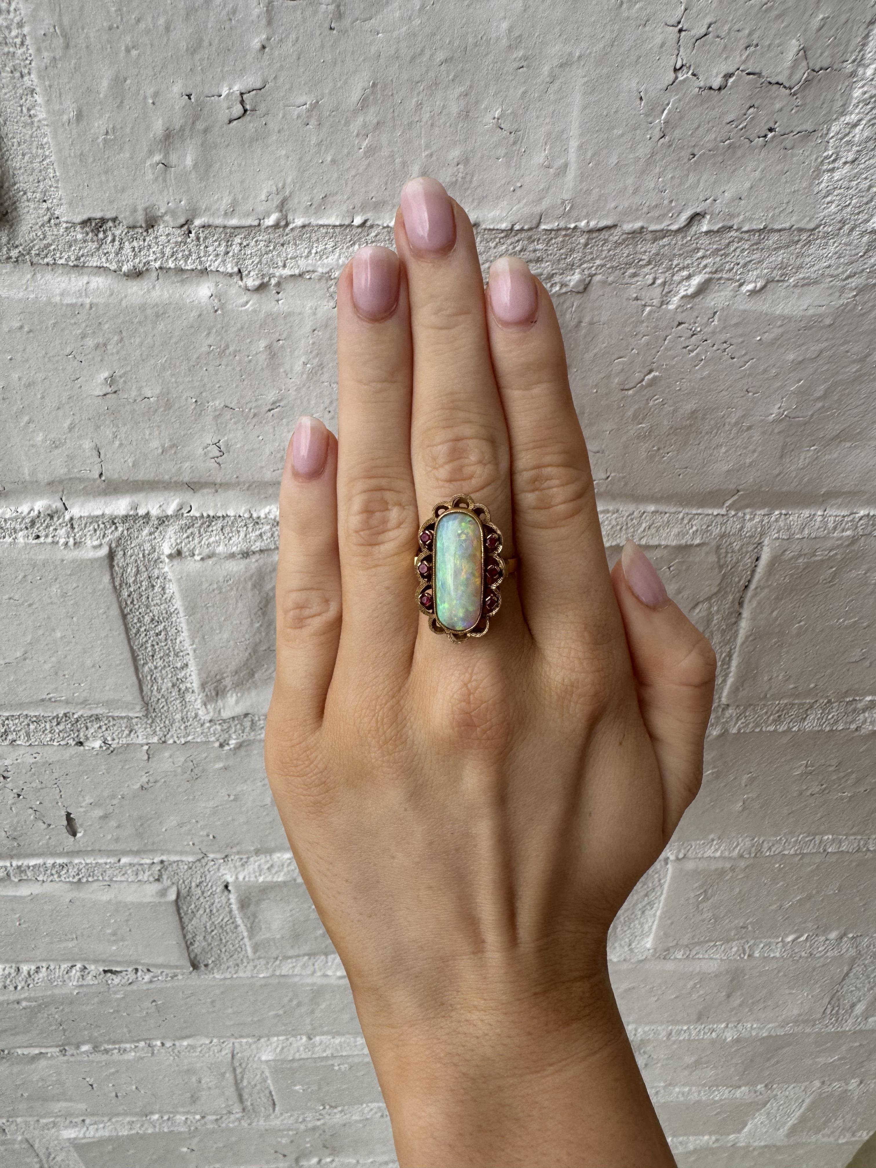 We are stunned over the beautiful vibrant colors of this opal!!!

Ring Details
Material: 18K Yellow Gold
Era: Retro 1940 - 1960
Head Length: 25.5mm
Head Width: 15.3mm
Head Height: 9mm
Weight: 6.7 Grams
Finger Size: 6 1/2
Sizable Upon