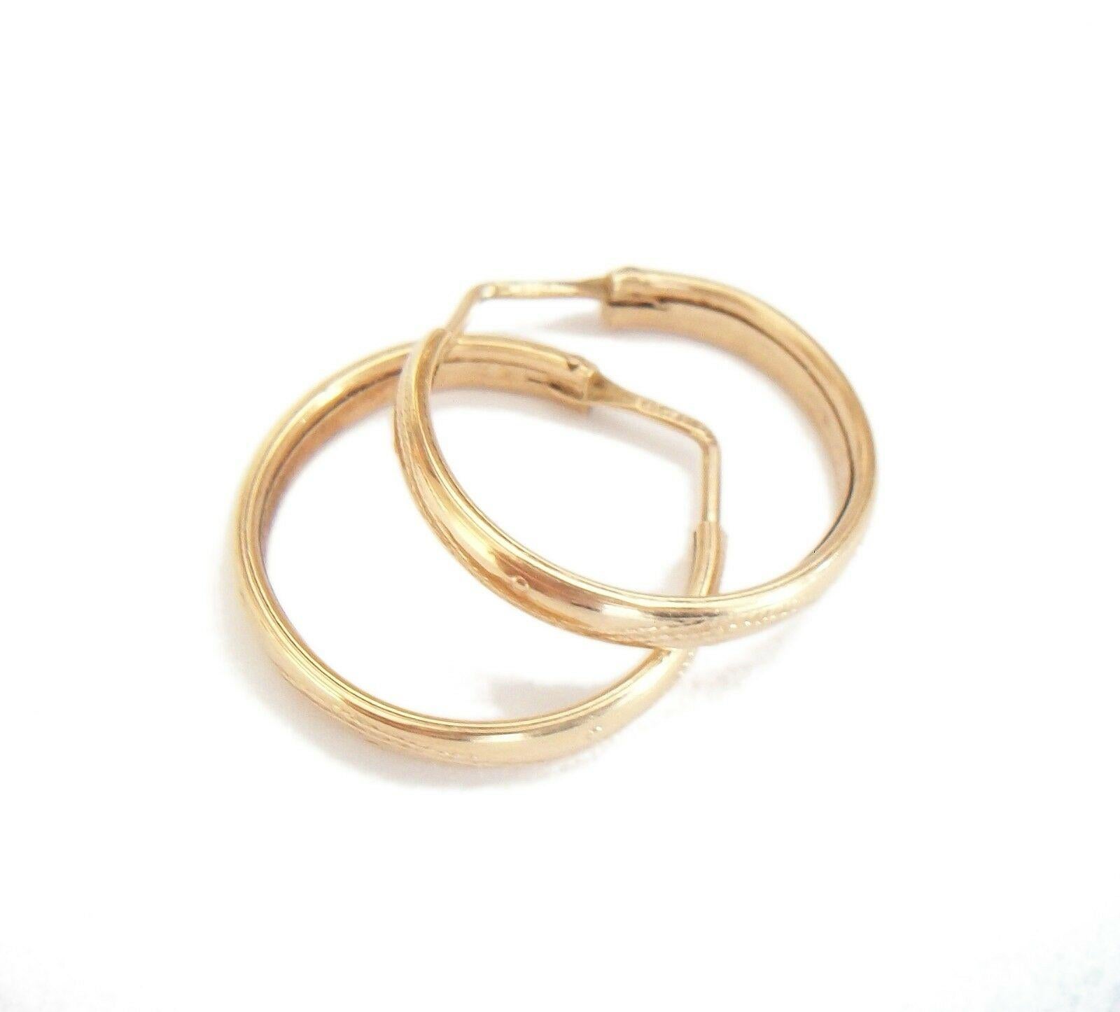 Vintage Vicenza 14K yellow gold hoop earrings - the hoops reverse stamped with a subtle meandering vine and raised rivet design - hand made - gold hallmarks 585 to each hook along with an unidentified maker number and 'VI' (Vicenza) - Italy - mid